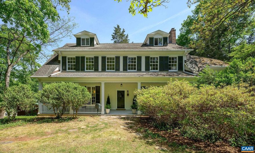 Historic Rugby Road Estate Available for the First Time in Half a Century. Built in 1917 in the Eugene Bradbury style, this remarkable estate features a main house with a deep front porch that opens to a gracious foyer, living room, and library. The generous dining room flows into an eat-in kitchen with antique cupboards. Throughout, you'll find Craftsman detailing, elegant built-in bookshelves, four fireplaces, and original hardwood floors. The ground floor includes a flexible apartment/office space that could serve as a main-level primary bedroom. The second floor boasts a four-room primary suite with ensuite bath, additional bedrooms, & an artisan-tiled bathroom. The third floor offers a cozy dormer room, bedroom, & bath. A covered back porch overlooks expansive landscaping with a flagstone terrace. The property's crown jewel is the writer/artist studio nestled in the back garden with a vaulted ceiling, skylight and sleeping loft. A detached garage/workshop provides additional functionality. The property is over an acre, offering privacy, mature shade trees, creative inspiration, & many possibilities for new owners to craft their vision. The location also provides easy walking access to UVA grounds, city parks, & the Corner.