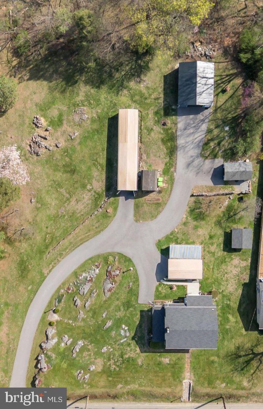 Charming 3-bedroom, 1-bath (capability for extra bathroom install), Dutch Colonial on 0.87 acres with Commercial/Residential use and Business Local District (BL) zoning, offering a rare combination of character, versatility, and functionality. This home also features a new roof and windows - 4 years. Connected to Washington County water and sewer, this move-in ready property is conveniently located near restaurants, stores, supermarkets, the Valley Mall, I-81, I-70, and is approximately 10 minutes from Hagerstown Premium Outlets.

The front of the home makes a strong first impression with historic slate front stairs leading to the front walkway and colonial-style entrance. Inside, fresh interior paint and thoughtful custom touches help set the tone throughout the home. Baseboard heating has been removed and replaced with floor and shoe molding throughout the finished areas, adding to the clean, finished look.

The kitchen offers granite countertops, a custom window breakfast nook and a built-in table designed to lift toward the ceiling for easier cleaning, with removable benches. All kitchen appliances convey. Access from the kitchen to basement and back porch.

The dining room features linoleum flooring over original hardwood, floor molding, chair molding and threshold molding. A handmade China cabinet and chandelier convey.

The spacious living room features a high ceiling, original freshly stained durable hardwood flooring, and a wood-burning stove equipped with a 7,000 BTU electric blower for heat. The front door entrance takes you directly into the living room. A real French door on the left side opens to the left-side porch. Switches in the living room operate the exterior light poles on the property. An LED lit stairway connects the living room to the upper level.

Entire 2nd floor is recently painted and has original hardwood flooring. All of the bedrooms have closets. Master bedroom has a handmade built-in vanity.  

The bathroom has been fully remodeled with custom finishes. Includes an oversized sink, ceramic tile in the shower with a marble shelf and marble in the rest of the bathroom. Leather-textured vinyl above the wainscoted walls. Bathroom has a custom closet with ample storage.

The attic is accessible from the top of the stairway by pull-down steps, offering ample storage space and foam insulation. Equipped with an automatic fan, cut off switch accessible via bathroom closet.

The basement includes recently painted walls, brand new hot/cold water plumbing supplying the whole house and a mud sink. Washer and dryer - 6 years old. Upgraded electrical, new PVC pipes, and new main support beams. 2 Trane air/heat units (4 years old), 1 in basement, 1 in attic.

Outside, the property continues to impress with multiple functional structures and unique outdoor features. There are 3 garages which hold 6 cars. All are fully equipped with electrical power and outlets throughout. The metal garage is equipped with its own separate breaker box and offers plenty of outlets. Attached to the one car garage is an open carport used for gardening tools.    A backyard shed can be used as a workshop/landscaping tools storage area and is currently under restoration. There is a cabin/office behind the picnic area and rock wall.

The picnic area includes built-in water and electric, a built-in mini barbecue, and furniture that conveys. Behind it, the historic Civil War rock wall adds character and outdoor appeal. The long blacktop driveway is 2 years old and allows for tons of parking. Outdoor gardens throughout the property with hundreds of perennials and coral carpeting that lines the rocks. There are 3 dogwood trees, 1 Magnolia tree, and 1 Elderberry tree.

Property is being sold as-is.