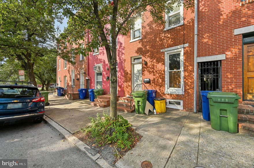 Motivated Seller!!! Offering $5000 Closing Assistance....  Welcome to 110 S Poppleton Street—an updated brick townhouse in the heart of historic Hollins Market! This spacious 3-bedroom, 1.5-bath home features fresh paint, new carpeting, updated kitchen appliances, modern vanities, and newly installed flooring throughout. Enjoy a light-filled layout with separate living and dining areas, a skylit eat-in kitchen, and an unfinished basement offering ample storage or future potential. Step outside to a charming front porch and a private, fenced rear garden—ideal for relaxing or entertaining. Located across from the B&O Railroad Museum and just minutes from Camden Yards, M&T Bank Stadium, UMD Medical Center, and the Inner Harbor, this home offers unbeatable access to shopping, dining, and city life. Perfect for homeowners or investors seeking a turnkey opportunity in a growing neighborhood!