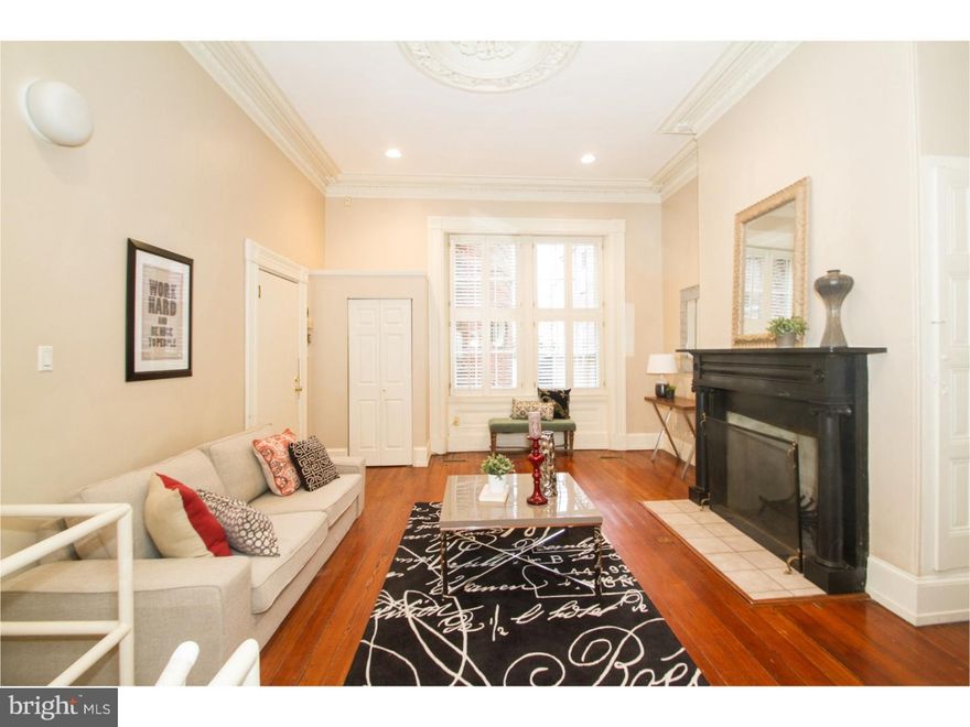 Combining old world elegance with modern day conveniences this bi-level condo in historic Girard Row is located along a picturesque Society Hill block. Enter in to a large living room with 12' ceilings, original plaster moldings, restored Pennsylvania pine hardwood flooring and a wood burning, King of Prussia blue marble fireplace. Move beyond to the generous Master Suite featuring a large walk in closet with auxiliary hidden storage above and a full bathroom which is easily accessed from the Living Area. The lower level, with tall ceilings and several windows allowing in a pleasant amount of natural sunlight, features an updated eat in kitchen with white cabinetry and Quartz counter tops. Also on this level is the 2nd bedroom and full bathroom, a laundry area with new, high efficiency washer and dryer and several closets and built-ins. There is beautiful porcelain tile flooring throughout this level. The location can't be beat within steps of 3 Bears Park, Pennsylvania Liquor/Wine store, Dry cleaner, Acme Grocery Store and Philadelphia Sports Club fitness center. Walk Score: 97. Transit Score: 98.