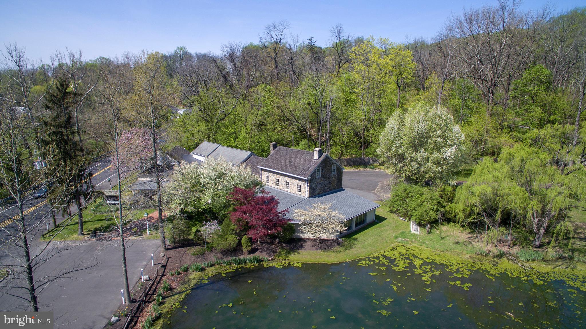 One of the most picturesque commercial properties on the 202 corridor, overlooking a large pond with fountains and frequented by wildlife such as blue herons, ducks, deer, and more, this long term corporate tenant-occupied property is great for an investor looking for stable rental income in a prime municipality where property values are premium. Average daily traffic exposure to 18,000 vehicles and located just over the bridge to New Jersey, this complex offers a large (5,300 sq ft on the first floor alone, over 7,000 SF total) space in an affluent area that is restrictive with commercial development, with no competing buildings of this scale. Across the road is a newer public park/nature preserve, and the property is just minutes to downtown New Hope, Doylestown, and major commuting roads to New Jersey, Philly, and NYC (the I-95/295 corridor and PA/NJ Turnpikes). The detached two bedroom cottage in the back has a history of long term tenants, who enjoy the pool, three car garage, and scenic views. Two parking lots (front and back), do not enter the property or approach the occupants without an appointment, consult listing agent for details and NDA.