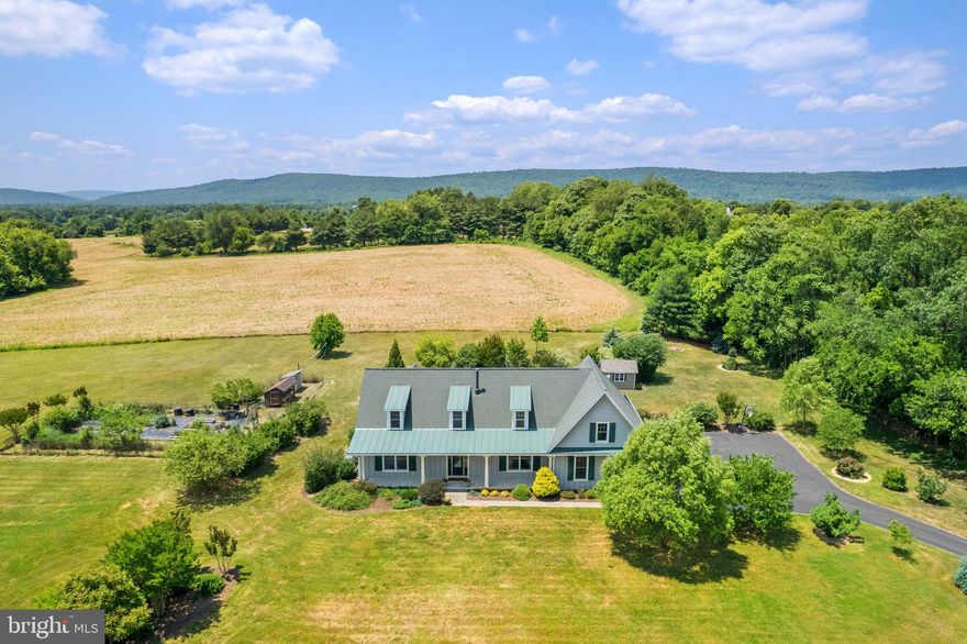 "Harmony Hill" is a beautiful custom built Cape Cod on 3 acres surrounded by heirloom trees, flower gardens and your own fish pond.  The garden design offers continuous blooms throughout the growing season.  Bring your furry and feathered friends.  There is no HOA here.  The chicken coop located is next to the fenced fruit and veggie garden. Wander through and pick peaches or figs from your own trees and bushes.  This is a lovely peaceful setting with natural beauty and abundant wildlife.  Enjoy the sunrise from the large front porch and sunsets from the expansive rear screened porch.  Enjoy cool evenings next to the fire pit.  There is also a shed for lawn and garden storage.  You'll find the hot tub tucked into a quiet corner of the back porch. The house has an open floor plan with main floor living and plenty of natural light.  Unique architectural details include arched doorways and transom windows plus antique inspired door hardware give this house a quaint feeling. The kitchen has granite countertops and newer appliances. Hardwood flooring throughout the main level including the primary suite. Work from home in the roomy office with internet by All Points Broadband.  The upper level is finished with 2 more bedrooms, a full bath and sitting room or office.  The basement was recently updated with Luxury Vinyl Plank (LVP) flooring and freshly painted. There are stairs that walk up to the side yard. Owner needs a post occupancy agreement until 10/31/2023. Live the Country life minutes to the Town of Lovettsville or Purcellville. Easy access to Routes 9, 7 and the Toll Road. Dulles Airport about 25 minutes. Washington, DC is about 30 miles. Love where you live!