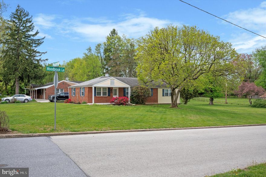 This charming,  corner ranch-style home offers a blend of classic design and functional living spaces. The open-concept layout seamlessly connects the living and dining areas to the spacious kitchen. Your 4 car shared driveway provides direct access to the kitchen and garage, facilitating easy entry and exit.
The residence currently has a wall removed between the second and third bedroom which can easily be put back up to accomodate three separate bedrooms. The primary bedroom boasts an en-suite bathroom with a tub and offers convenient access to a laundry room that also leads directly to both the garage and driveway.  Another full bathroom is situated in the hallway to serve the household's needs.  Storage solutions are ample, with spacious hallway closets enhancing organizational options. The home is equipped with radiant heating on the main slab, while the addition features a crawl space with radiator hot water heating. An oil system heats the water, and the hot water system operates on a summer/winter hookup. Three window units are included and can be found in the garage.  The expansive yard is a standout feature, offering 0.45 acres of flat space for various activities and includes a shed for additional storage.  The garage door belongs to the neighbor. Access to our garage is only through the door.