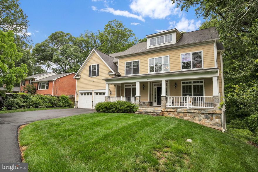 Elegant Custom Colonial in Coveted Bannockburn! 
Welcome to 6913 Wilson Lane, a stunning Colonial home custom-built in 2015 by the current owners, located in the heart of the highly sought-after Bannockburn neighborhood. Set on nearly half an acre of flat, private, and wooded land, this beautifully maintained residence offers timeless design, modern comfort, and tranquil surroundings. Boasting 5 spacious bedrooms and 3.5 baths, the home features gleaming hardwood floors on both the main and upper levels, fresh interior paint, and an inviting front porch—perfect for morning coffee or evening relaxation. A gracious foyer opens to a formal living room and dining room, ideal for entertaining. The heart of the home is the chef’s kitchen, complete with granite countertops, an expansive 9-foot center island with breakfast bar, stainless steel appliances, and abundant cabinetry. A main-level bedroom or study, powder room, and convenient laundry room provide additional versatility. The large two-story, light-filled family room includes a gas fireplace and plush carpeting, creating a warm space for everyday living. Upstairs, the large primary suite features a spa-like bath with dual vanities, a separate soaking tub and walk-in shower, and a large walk-in closet. Three additional large bedrooms and two- full baths complete the upper level. The unfinished walkout basement with its 9-foot ceiling is a blank canvas, already outfitted with rough-ins for a full bath and wet bar, offering endless possibilities for future living space, a gym, media room, or guest suite. Outside, enjoy year-round beauty in a serene, park-like backyard, ideal for gatherings or peaceful retreats. In the spring, the circular driveway and retaining wall burst with vibrant, multi-colored azaleas, adding seasonal charm to the lush landscaping. Additional features include dual heating and cooling systems (2023 HVAC system upstairs), a two-car garage, and multiple flexible living spaces throughout the home. Perfectly situated near major commuter routes, downtown Bethesda, Glen Echo Park, and the C&O Canal trails, this home is located within the prestigious Walt Whitman school cluster. Combining thoughtful updates, elegant design, and an unbeatable location, 6913 Wilson Lane is a rare and exceptional opportunity in Bannockburn.