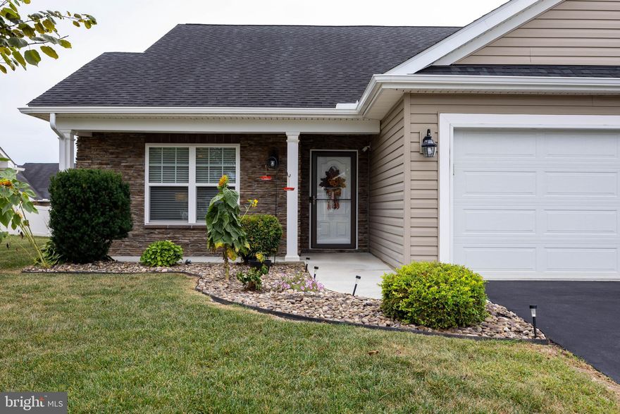 Welcome to this sought-after 3 bedroom, 3 bath villa located in the desirable Spring Mills community. Residents here enjoy fantastic amenities including walking paths, a community pool, tennis courts, picnic areas, and a Tot Lot.

Designed for easy living, this home offers spacious main-level living along with a versatile upper-level retreat complete with a full bath and walk-in closet—perfect for guests, a home office, studio, or craft room.

The wide foyer opens to a bright and airy floor plan featuring a cathedral-ceiling living room with hardwood floors and access to a covered rear porch for private outdoor relaxation. The kitchen is a chef’s delight, with 42" cabinetry, Corian countertops, a center island, stainless steel appliances, large pantry, and an adjacent dining area with room for a china cabinet and large table. You'll also find pull out shelving in the cabinets and under cabinet lighting.

The primary suite is privately tucked away and was extended an additional 6 feet, offering space for a sitting area or larger furnishings. It features a walk-in closet and an ensuite bath. A guest bedroom and bath are conveniently located off the foyer, providing a welcoming retreat for visitors.

This villa is thoughtfully enhanced with a Deaf/Hard of Hearing lighting alert system, adding peace of mind and accessibility. Additional highlights include remote control blinds and ceiling fan/light fixtures, a two-car garage with extra storage and a utility closet. 

This home combines comfort, functionality, accessibility, and community living—ready to welcome its new owner!