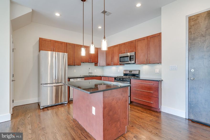 Spacious condo with PRIVATE ROOF DECK and 1-CAR PARKING! These homes have large windows, solid wood doors, and maple flooring throughout. The living area leads to an open kitchen. The kitchen boasts thoughtful details such as 42" cabinetry with soft close doors and drawers, under cabinet lighting, stainless steel appliances, quartz countertops and an island with seating and pendant lighting. Down the hall, there are two spacious bedrooms to create your own oasis. Other amenities include a laundry room with a washer and dryer and two sets of sliding glass doors that lead to a private balcony. The building has an elevator, intercom system and gated parking. The location is just a few blocks from the action in Fishtown and Northern Liberties- just a short walk to local favorites such as the Piazza, Frankford Hall, Fette Sau, Johnny Brenda's, La Colombe and More!