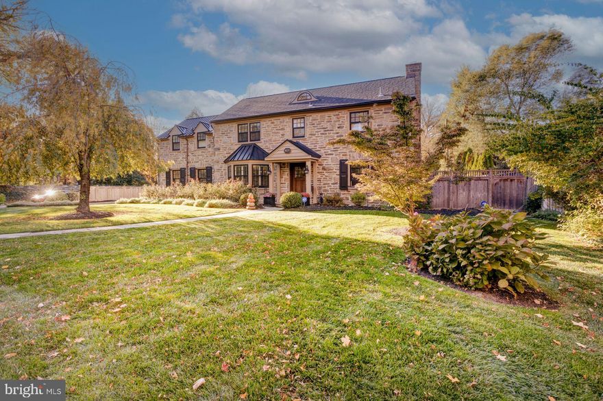 Nestled in the highly sought-after Springfield Township in Montgomery County, and close to Chestnut Hill, the Morris Arboretum, and Forbidden Drive, this stunning stone center hall colonial offers the perfect blend of elegance and comfort. This home is a true delight, greeting you with beautiful landscaping designed to stun year-round.
In the late spring through fall, the front gardens are abundant with pink roses and purple catmint. The hydrangea and hosta garden, situated on the inside front fence, blooms from the late summer through fall. The hillside gardens thrive with roses and a plethora of blooming shrubs and perennials all season long.
Step inside to discover an English cottage-like interior, featuring warm wood floors, deep windowsills, crown molding, and plantation shutters throughout. The living room boasts a cozy gas fireplace, perfect for chilly evenings, while the dining room and center hall showcase elegant board and batten wainscoting.
The dining room opens to a cook’s dream of a custom kitchen, with quartz counters, gas cooking, subway tile backsplash, and high quality Thermador appliances. A first-floor powder room is situated in the center hall for added convenience.
Upstairs, the primary bedroom suite is a serene retreat, with an amazing ensuite bathroom featuring twin vanities, quartz counters, a tiled stall shower, clawfoot tub, and a private water closet. Two additional bedrooms, currently configured as a media room/library and a large walk-in closet, offer great flexibility. A second hallway, located beyond these rooms, leads to an upgraded hall bathroom featuring marble floor tile and a glass shower enclosure. A guest suite with a full bath, including a clawfoot tub, completes the upper level.
A second set of stairs leads up from the kitchen and provides convenient access to the guest suite and hall bathroom.
Outside, the private back garden features a bluestone patio, arbor vitae hedge, and a gorgeous crepe myrtle that blooms pink in the summer with foliage that turns vivid orange in the fall. Enjoy the bubbling fountain, a right-sized lawn, and landscape lighting, perfect for outdoor entertaining. Wrapping around the side of the home, the patio continues to reveal a Sundance® Tacoma spa for year-round enjoyment and relaxation.
An unfinished, yet clean and truly functional basement provides excellent space for a home gym, storage, or project space, and features an infrared sauna. Additionally, this home boasts an attached 2-car garage, offering convenience, parking, and additional storage space. There is additional storage space in the attic.
This home is close to the myriad of restaurants and shops in Chestnut Hill, Erdenheim, and Wyndmoor as well as walking trails and parks. 
Don't miss the opportunity to make this stunning property your own. Schedule a showing today!