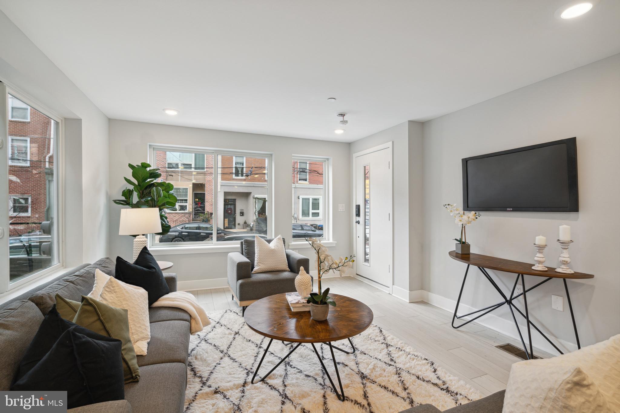 This bi-level condo is a sleek 1,250 square foot masterpiece with modern finishes that hit all the right notes. The light grey walls and crisp “Whiteby” floors set a chic, sophisticated vibe from the moment you step in. The kitchen? A cook’s dream. White cabinets and countertops with marble accents in soft grey give it that high-end, polished feel. Whether you’re whipping up your latest creation or just reheating leftovers, this kitchen has you covered. By night, the island’s glass pendant lights throw a cozy glow over the entire space, making the living and dining areas even more inviting. Natural light pours in through double-sided windows on the main floor, perfect for bringing your indoor plants to life. Downstairs, you’ll find two spacious bedrooms and two bathrooms with 10-foot ceilings that add a touch of luxury. The oversized master suite is a true retreat with an ensuite bath that features luxe penny tile floors, white subway tiles, and dual sinks for ultimate convenience. The second bedroom is versatile—use it as a guest room, home office, or yoga studio. It’s your call! This spot is all about location too. Just a 13-minute walk to Frankford Ave, 14 minutes to Liberties Walk, The Fillmore, and a quick 21-minute stroll to Franklin Music Hall. Plus, the trolley is only a block away, making it super easy to get around. Come see it for yourself. You won’t be disappointed.
