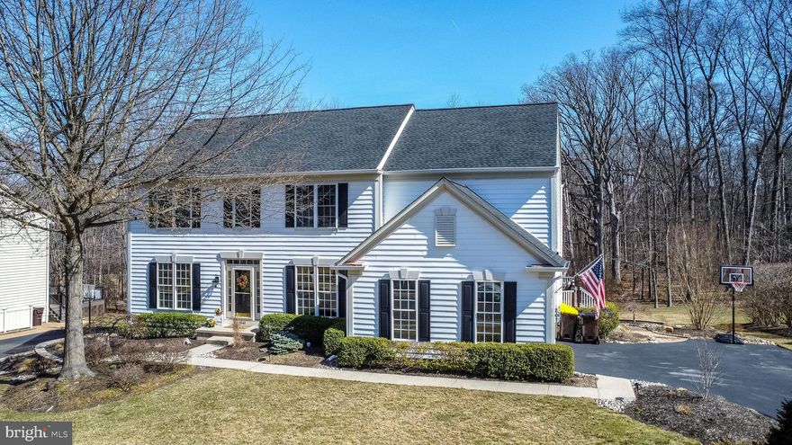 This house will check all of your boxes!  Nestled on a meticulously manicured lot and backing to township woods  in the highly sought-after Chestnut Creek neighborhood, this exceptional home offers a blend of elegance, comfort, and modern convenience.  Upon entry, you'll be greeted by a dramatic two-story foyer that flows seamlessly into the formal living and dining rooms, complete with wainscotting and crown molding,  The bright, open floor plan is accentuated by a dual staircase, allowing for easy navigation throughout the home. The main floor also boasts rich hardwood floors, custom millwork, a dedicated office with a built-in desk, and a powder room. Large windows throughout allow for abundant natural light.  The heart of the home is the gourmet kitchen, featuring a center island, newer stainless steel kitchen appliances, Thermador 5 burner gas cooktop, new double wall ovens, granite countertops, double sink, desk area and a butler's pantry.  Perfect for entertaining, the kitchen provides direct access through a triple pane glass door to an extra spacious 2 tiered Timber tech deck with lighting, overlooking the beautifully landscaped yard. The kitchen also opens into a soaring two-story family room, providing  a gas fireplace—ideal for gatherings and cozy evenings.  A conveniently located main floor laundry room, equipped with a laundry chute, and cabinetry  adds to the home's functionality.  Upstairs, the master suite is a true retreat, featuring a tray ceiling, wainscotting, custom walk-in closet with organizers, ceiling fan and a completely renovated, luxurious master bath with double sinks, a soaking tub, stall shower, and a private water closet. The second-floor hall bath has also been completely renovated, complementing the three additional generously sized bedrooms that provide ample space for family and guests.  The beautifully finished lower level includes a large entertaining area for TV, play, and lounging, as well as a flex space for work, crafts or games, while relaxing by a warm wood pellet stove.  French doors lead to another flex room, perfect for use as an office or fitness room and a full bath adds convenience on this level.  Additionally, there is an abundance of unfinished space for storage, complete with built-in shelving.  Added amenities include a newer roof, gutters, and shutters, newer two-zone gas heating and central air, a house generator, a freshly painted interior, recessed lighting, and a Culligan water softening system.  The seller is providing a one year America's Preferred Warranty with the upgraded Buyer's Premier Coverage Plan to the lucky buyer!  This home offers a perfect balance of style and functionality with its thoughtful design and modern updates. Its prime location is just minutes from 309, the PA Turnpike, train station, downtown Ambler, parks, ball fields, library, schools, restaurants, and shopping.