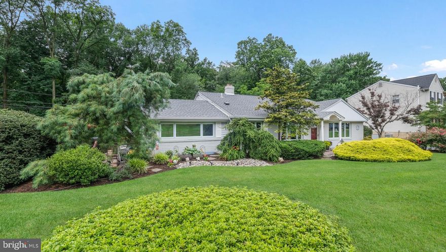 Stunning four bedroom, three full bathroom home that has been lovingly maintained in the award-winning Abington School District!  Situated on over a third of an acre, this handsome home is one-of-a-kind. All throughout the home, you will notice that not one detail has been overlooked. As you enter into this home the main level opens up into the living room and dining room. These rooms are highlighted by gleaming hardwood floors, abundant natural light with spacious picture windows, and peaked ceilings that create just the right amount of elegance and drama. The updated kitchen and family room sit just beyond the dining room. These rooms are open and bright, featuring a wall of windows framing the serene backyard, with a wooded setting and paved patios. Granite countertops, stainless steel appliances, tiled floor and abundant cabinet space are just a few of the features in this charming space. Up the wrought iron and wood railing steps to the next level, the primary suite offers custom built-ins, a walk-in closet, and a primary bathroom. Two additional bedrooms and a full bathroom complete this level. The lower level opens up into another living space or sitting room, more natural light, a laundry room, and a full bedroom and bathroom. This spacious bedroom has a private entrance and access to a kitchenette which allows so much flexibility to this level! It can be utilized as a playroom, an in-law suite, home office, extra bedroom for extended guests, or for the college kids when they are home. Just below this level there is more space that can be used as a home gym, great for storage, craft/hobby room or game room. The outdoor space is very inviting and accented with an underground irrigation system, EP Henry patio & walkways, and a natural gas grill which make this a wonderful outdoor and entertaining space! The oversized garage has an attic for storage and space for a workshop. This home is in absolute move-in condition and is waiting for you!