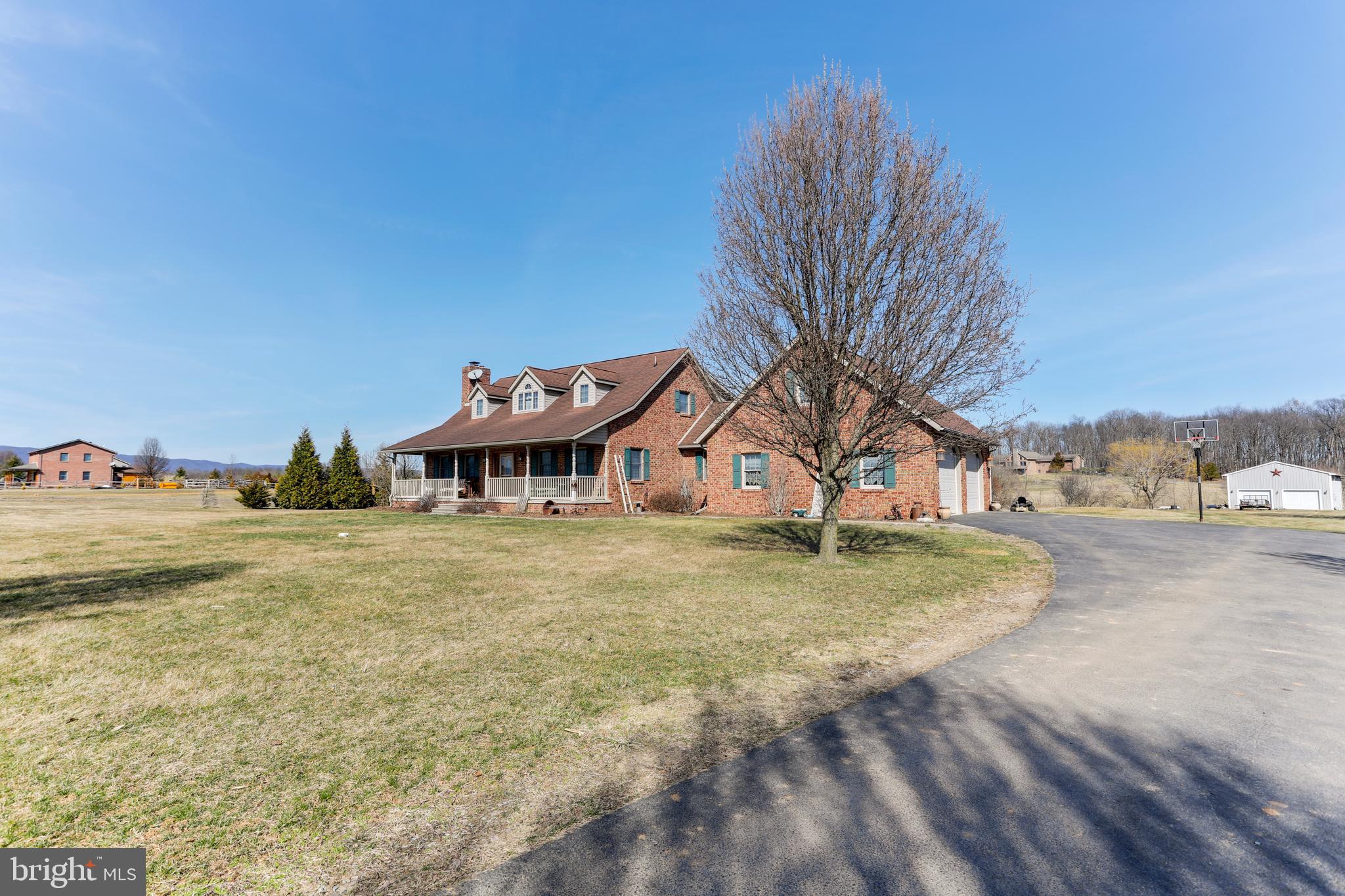 Beautiful spacious brick cape cod home situated on just over 2 acres with mountain views from your front porch and lots of space to roam with 3 large bedrooms and 2.5 baths, large eat in kitchen and separate dining room for entertaining. The living room features a stone fireplace to keep you warm on cold evenings, as an added bonus the unfinished basement has a wood burning stove and great potential to make  a large family room in the future. This home has a newer heat pump and backup sources of heat also. Along with the attached two car garage the property also has a large two bay building for added storage.  Please note that the public tax record has not updated as of yet and the lot size is 2.2 Acres. More pics to come.