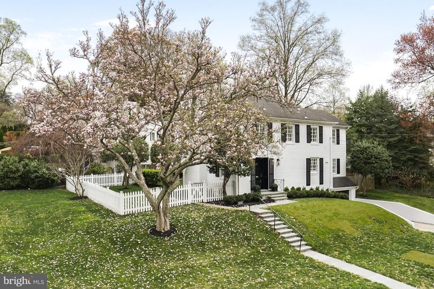 Turnkey perfection on a gorgeous corner lot in Westmoreland Hills - fabulous curb appeal and with a white picket fence, too! Originally built in 1955 and later expanded, the home has been further updated and improved by the current owner, with an attention to detail that is often overlooked - down to the replacement of electrical receptacles, light switches, heating and cooling vents and more. The front door opens to gleaming hardwood floors throughout and a welcoming foyer with open stairway to the second level. The living room with fireplace (currently wood burning but with a gas line in place), dining room and family room are all window filled and with views of the back patio and garden, and the living and family room each give access to the level walkout patio and yard outside. A sparkling kitchen with recently refinished cabinetry, granite countertops and stainless appliances provides amazing storage and workspace and the powder room has just been fully renovated. Three large bedrooms (converted from what would have been four with the addition), including a primary with renovated ensuite bath and dual closets plus an additional updated hall bath are on the second level. A recreation room with fireplace, laundry area, storage room, utility room with quarter bath and access to the one-car garage are in the lower level. Directly across the street is the entrance to Little Falls and Capital Crescent trails and access to beloved Westmoreland Park, with its playgrounds, fields, tennis courts and more. Hop on the trail to make your way to Bethesda and all it offers, or take a stroll to the shops and offerings of Spring Valley, including Millie’s, Compass Coffee, and Wagshal’s, among others. Whole Foods is also nearby, across from the newly rebuilt Westbard Square with its many shops and amenities. Friendship Heights is close as well, providing access to additional shopping, dining and Metro. Downtown DC and points in Maryland, Virginia and beyond are easily reached, including all area airports. Westmoreland Hills is known for its close knit community, and the voluntary Westmoreland Citizen’s Association is extremely active and hosts approximately a dozen events annually. So close to everything, this location is the perfect choice for those who desire a mature, established neighborhood with all of the conveniences of the city right at hand.