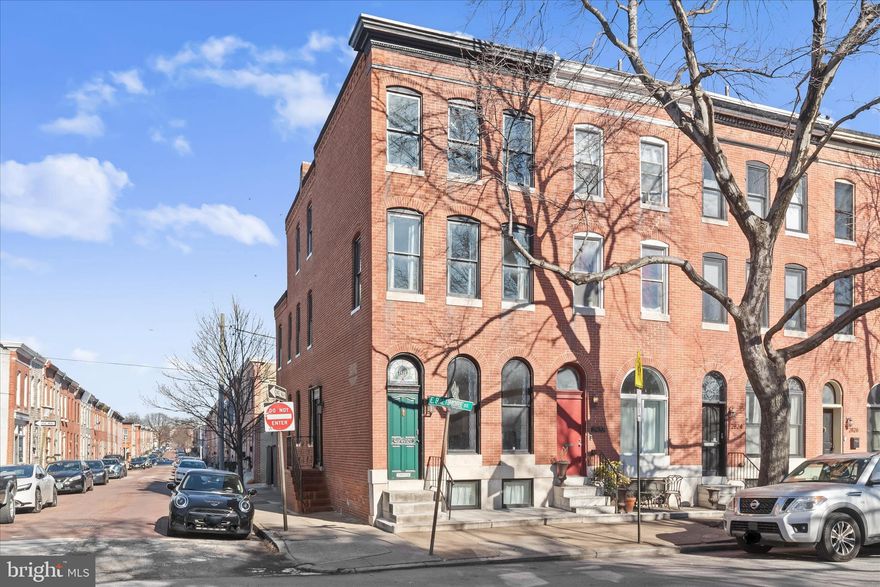 This beautifully renovated end-of-row brick townhouse was thoughtfully transformed in 2022 and offers effortless, move-in-ready living in one of Patterson Park’s most desirable locations, directly facing the park’s expansive green space, with 7 years remaining on the CHAP tax credit .  A rare off-street parking pad with EV charging adds modern convenience to city living. The home spans three finished levels highlighting hardwood flooring throughout, plus a large unfinished lower level, and features four bedrooms and two-and-a-half baths designed for flexibility and comfort. The main level showcases a sleek, contemporary kitchen with 42-inch cabinetry, a generous island, induction cooking, and stainless steel appliances, complemented by a convenient half bath and a secondary side entrance for easy access.
The second level hosts two bright and spacious bedrooms, an updated full bath with dual vanity and tub/shower, and a dedicated upper-level laundry area. On the third floor, you’ll find two additional oversized bedrooms and another full bath, ideal for guest accommodations, home offices, or private retreats.  Extensive upgrades include a new roof and skylights, dual-zoned HVAC with central air, water heater, new electrical and plumbing systems, updated flooring throughout, fully renovated kitchen and baths, and the addition of the parking pad.  All of this is set just steps from Patterson Park, with unbeatable proximity to neighborhood favorites, shopping, dining, and vibrant city amenities. With major renovations complete, this home presents a rare and compelling opportunity.