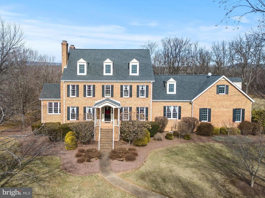 Sophisticated - immaculate - spacious - gorgeous! This 1-owner, quality-built custom home was constructed with attention to detail at every corner. The new owner will get to enjoy the gourmet kitchen with a Jenn-Aire cooktop in the island, Double wall oven, 3 brick fireplaces (2 wood burning and 1 with a heatolater), an irrigation system in place with its own well pump, a reverse osmosis system, 2 staircases, recently re-finished hardwood floors, a vaulted wood ceiling in the sunroom, closets galore, and custom built-ins throughout. You don't want to miss the huge bonus room that would make someone an awesome bedroom! This home has been lovingly maintained. There is lots of natural light to enjoy the inside spaces. Outside features include front and rear covered porches. You can also enjoy the screened rear porch as well as the open-air rear deck. The well landscaped 5.5 acre-lot is nestled in a small, private development just outside of Winchester but still very convenient to shopping, schools, commuting, and several nearby churches. See the lengthy list of special features and recent upgrades!