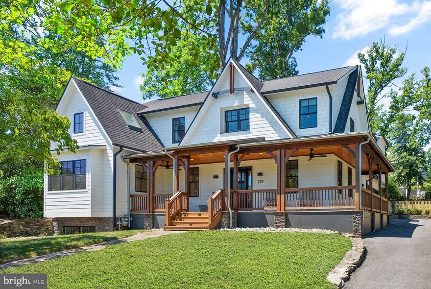 Located in the heart of Lyon Park, this gorgeous craftsman-style home sits on an enormous 15,716 sq ft lot (0.36 acres) and has been remodeled from top to bottom with high-end custom finishes throughout!  The first thing you will notice is the charming wrap-around covered front porch overlooking a quiet street. Step inside to find gorgeous stained-in-place solid white oak floors flowing throughout the main and upper level. Incredible gourmet kitchen features top-of-the-line Sub-Zero, Wolf and Cove appliances, solid maple flush inset cabinetry, and honed marble counters with hand-made zellige tile backsplash. The dining room off of the kitchen has built-in buffet cabinetry and soaring vaulted ceiling with skylights and unique exposed wood beams. Open concept floorplan with the kitchen overlooking the large living room with built-in entertainment center. Floor to ceiling sliding glass doors seamlessly extend entertaining from the kitchen to the inviting screened in porch. Immerse yourself in nature and enjoy exploring the secret gardens and hidden trails throughout the backyard. The private backyard is large enough to accommodate a pool or accessory dwelling unit (ADU),  and has a flagstone patio, perfect for grilling and entertaining. The main level also features a large mud room, office and half bath. On the upper level you will find 4 bedrooms and 3 full baths. The large primary suite boasts a vaulted, beamed ceiling and a show-stopping en-suite bath.  Thoughtfully designed, this luxurious bathroom features a dual-entry open shower, heated flooring, separate vanities, free standing tub, designer fixtures and custom wall-to-wall built-in wardrobe cabinetry. Off the upper level hall you will find a private deck, the perfect place to enjoy a morning cup of coffee. Princess suite with ensuite bath, 2 additional bedrooms, hall bath and spacious laundry room complete the upper level. Head downstairs to the walkup lower level featuring a spacious rec room, 5th bedroom, full bath and media/theater room with top-of-the-line audio system and speakers. The oversized 600 sq. ft. two car garage is insulated with a heating and cooling system, epoxy floors and kitchenette. Additional upgrades include a whole home auto-standby generator, 3M security film on all main floor and basement windows for security and UV protection, large stand-up attic for extra storage, whole-home wired sound system, custom millwork and designer lighting throughout. This beautiful home is turnkey and has everything you could ever need! Escape to the tranquility of suburban life while still being only minutes from the city!
