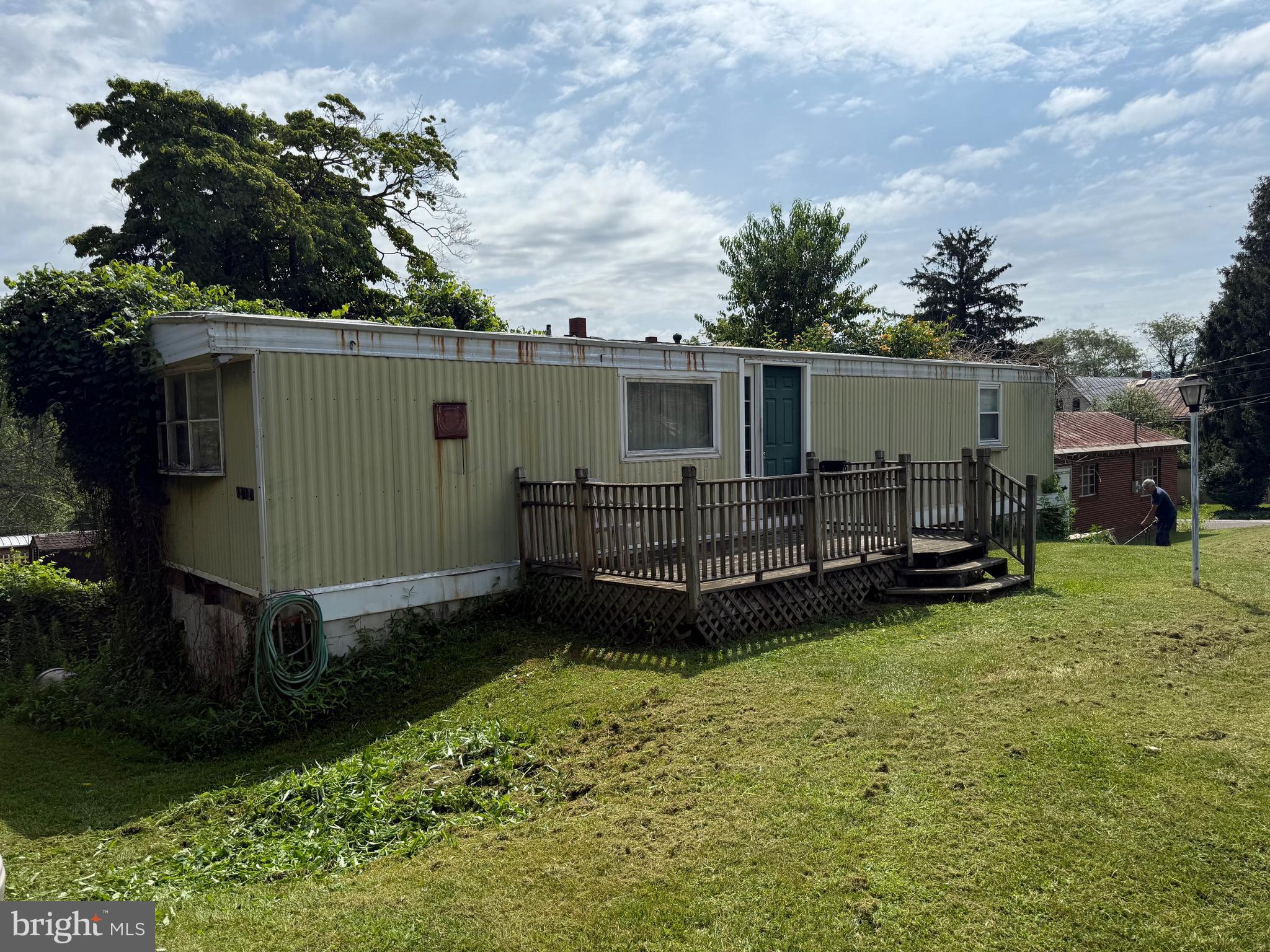 One bedroom single wide mobile home with basement. Needs major TLC, soft spot in floor, use caution when entering. Two large garages both have electric one had propane heat and a large air compressor which remains. First garage is 47.5 feet long 16 feet wide this garage Electric is on a separate meter which would make rental very easy. All shelving remains in both garages second garage is 34.5'x24'. The propane tank is owned and remains with the sale which is almost 3/4 full.