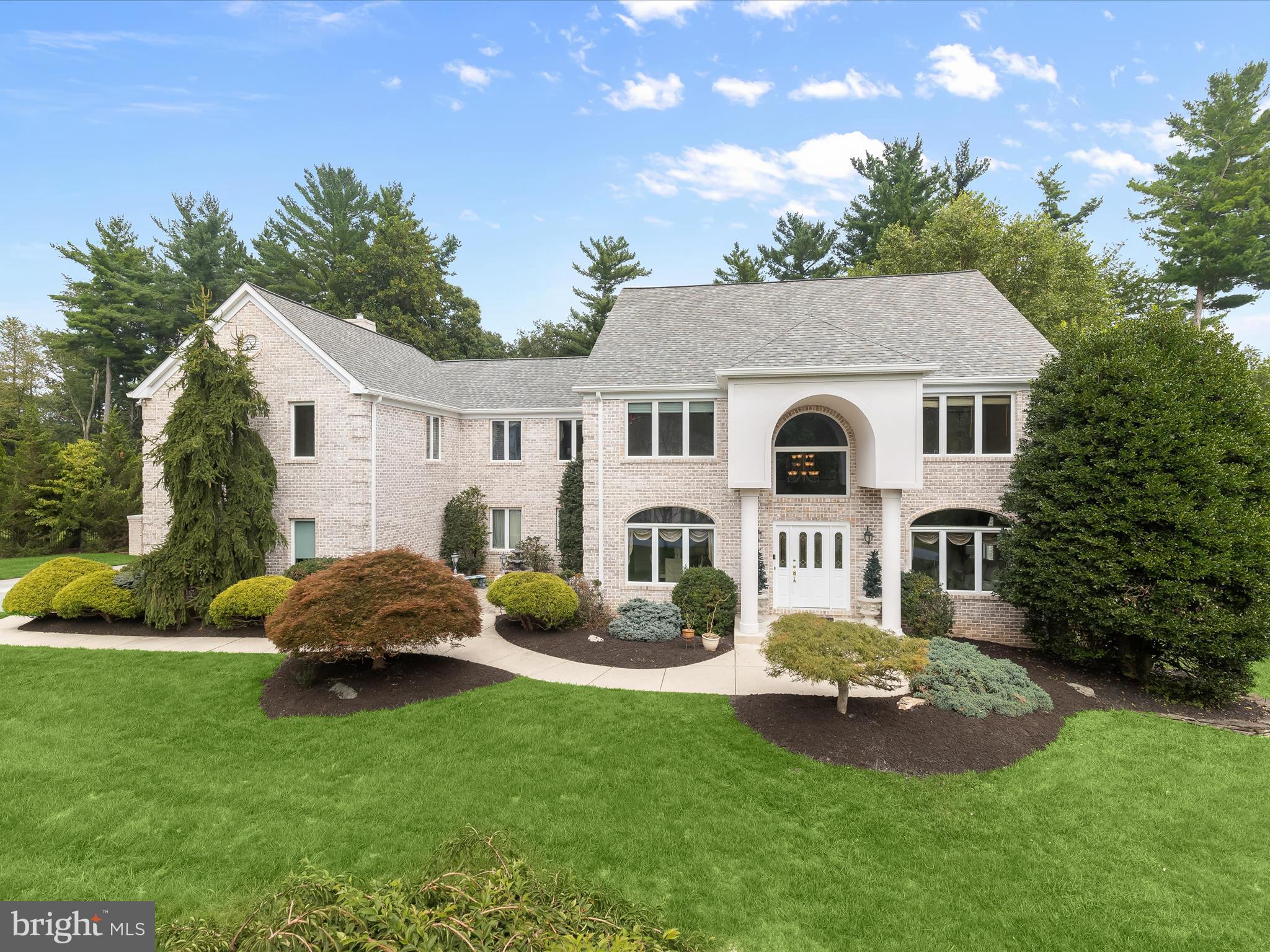 Welcome to timeless elegance in the highly coveted Beaver Creek Estates community. Set on over 2 acres of pristine, professionally landscaped grounds, this stately brick colonial offers an exceptional outdoor oasis, ideal for both grand entertaining and peaceful retreat. The backyard is a private sanctuary, featuring a spacious patio, cozy fire pit, secluded sitting areas with views of mature trees, lush gardens, and a sparkling in-ground pool surrounded by serene beauty. Step inside through the dramatic two-story foyer or the expansive 4-car garage and discover a thoughtfully designed traditional floor plan tailored for refined living. The formal living room features rich hardwood flooring, crown molding, recessed lighting, and a bay window adorned with a striking Palladian accent. The formal dining room impresses with a unique tray hexagon ceiling, ceramic tile flooring, and French doors opening to a charming front patio with a tranquil water feature, perfect for al fresco dining or evening gatherings. Classic columns introduce the grand and open family room, highlighted by soaring ceilings, a custom-built-in entertainment center, double crown molding, and a gas fireplace with a detailed dentil molding mantle flanked by floor-to-ceiling windows that bathe the space in natural light. The chef’s kitchen is beautifully equipped with granite countertops, a center island, 36” cabinetry with glass-front accents and a planning station, stainless steel appliances, double sinks, a breakfast bar, and elegant crown molding. A sunny breakfast area connects the kitchen and family room for effortless flow. A fully outfitted wet bar includes a beverage cooler, wine storage, icemaker, custom pull-out cabinetry, crown molding, and recessed lighting, ideal for entertaining. A stylish powder room completes the main level. The upper level features a luxurious primary suite with plush carpeting, a double-sided gas fireplace between the sleeping and sitting areas, two walk-in closets, a linen closet, and a versatile laundry/sewing room. The spa-inspired en-suite bath includes French door entry, a dual vanity, a walk-in shower, and a jetted soaking tub, offering the ultimate in comfort and relaxation. Two additional en-suite bedrooms, along with a fourth bedroom and a well-appointed hall bath, complete the upper-level sleeping quarters. The fully finished lower level offers versatile space for work, play, and relaxation. A private office or gym features crown molding, chair rail detailing, recessed lighting, and plush carpeting. A generous recreation area includes built-in shelving for a TV and speaker system, while an additional bedroom suite, powder room, laundry room with sink and storage, and multiple storage areas enhance the functionality of the space. Walk-out access to the rear yard ensures seamless indoor-outdoor living. Conveniently located near major commuter routes including MD-140, I-695, and I-795, this extraordinary property offers easy access to both Baltimore and Washington, D.C.