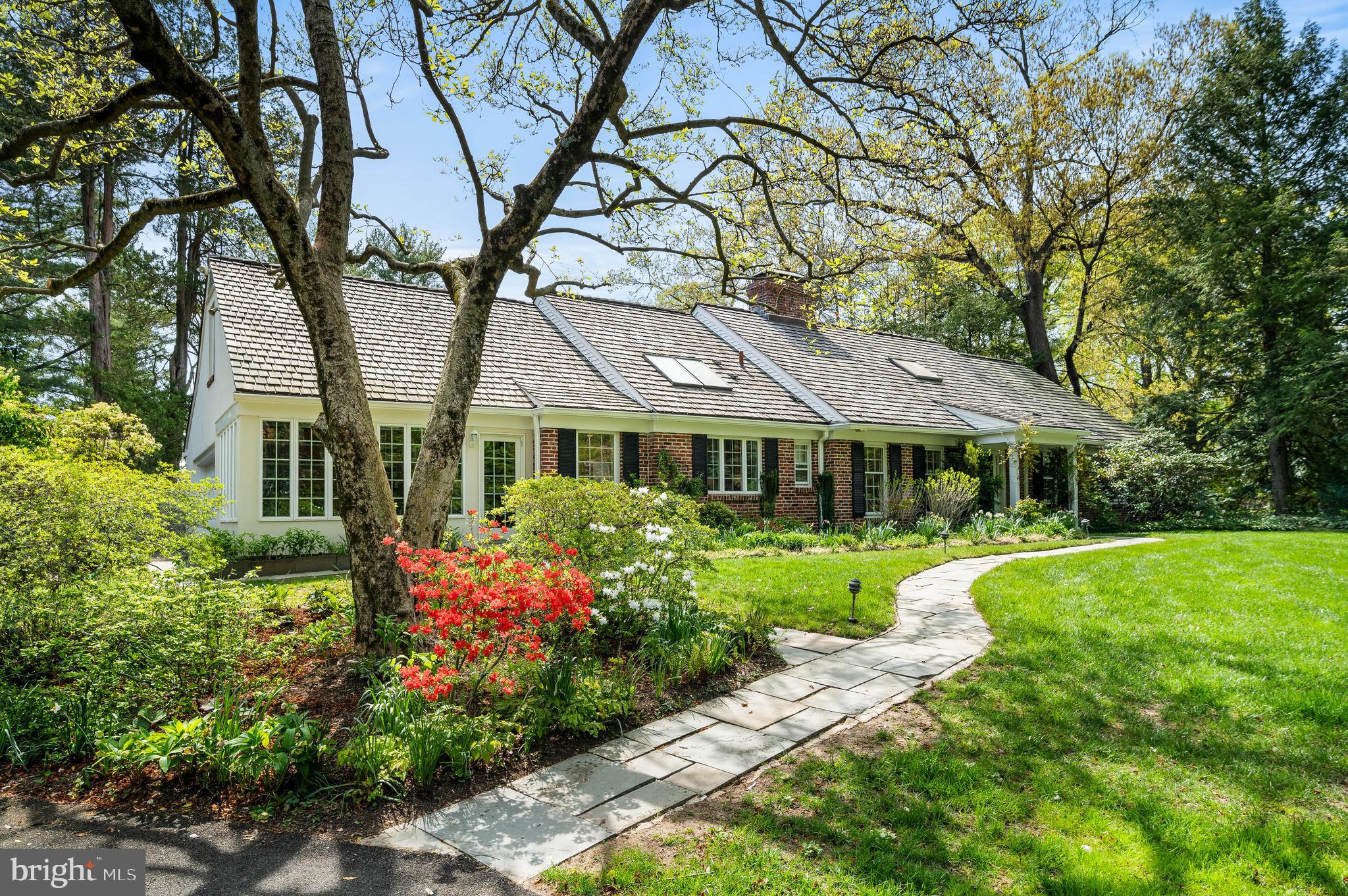 Welcome to 520 W Mermaid Lane, a charming and beautifully maintained home tucked away on an exceptional, picturesque lot in Chestnut Hill. This lovely property is surrounded by lush perennial gardens, mature trees, and thoughtfully designed landscaping.
As you enter the two-story foyer, a cozy sitting room with a gas fireplace framed by built-in shelving and an adjacent powder room creates a warm and welcoming space. The sunlit kitchen features a center island with granite countertops, stainless steel appliances, and opens to a bright breakfast room with built-in cabinetry, surrounded by windows offering lovely views of the front gardens. This area also provides convenient access to both the front yard and the rear two-car garage.
The adjacent dining room offers glass doors leading to the rear patio and opens to the spacious living room. Filled with natural light from a wall of glass sliders, the living room features an additional gas fireplace and overlooks the serene slate patio and pool.
The first floor offers two bedrooms: one with dual closets and direct access to a full hall bath, and a larger bedroom with an en-suite bathroom featuring dual sinks and two closets—an exceptional secondary primary suite option. This bath also offers direct access to the backyard, ideal for days spent enjoying the pool.
Upstairs, the generous primary suite (or guest suite) includes a large walk-in closet and an en-suite bath with a double vanity, walk-in shower, and separate soaking tub overlooking the backyard. A cozy open sitting area connects to the suite, offering flexible space for work or relaxation. This level also features an additional guest bedroom with pocket doors leading to a walk-in closet, a second-floor laundry room, a full hall bath, and a versatile bonus room that can serve as a playroom, exercise space, or additional bedroom.
Additional highlights include an unfinished basement ideal for storage, a home generator, and a backyard designed for easy living. The expansive slate patio with a retractable awning is perfect for al fresco dining and leads to a spacious lounging area beside the in-ground pool. The flat, grassy lot offers rare privacy, bordered by mature trees.
Ideally located just minutes from the St. Martins train station, the vibrant shops and restaurants of Chestnut Hill, and the scenic trails of Wissahickon Valley Park, 520 W Mermaid Lane offers a welcoming lifestyle with seamless indoor-outdoor living in one of Philadelphia’s most beloved neighborhoods.