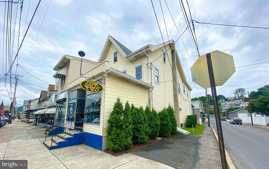 Extraordinary Investment Opportunity! This property has it all   two possible main level business locations, two upper level apartments, and an oversized garage all just steps from the reinvigorated downtown Tamaqua and located on a prominent street with ample visibility! The ground floor is ideal or one business to span both sides or can be easily divided to house two separate entities. The two apartments feature one-bed and three-bed floorplans. The single door garage offers ample room for storage beyond an auto! The property is two buildings, however only offers for both parcels will be entertained. Property is being offered in as is condition.