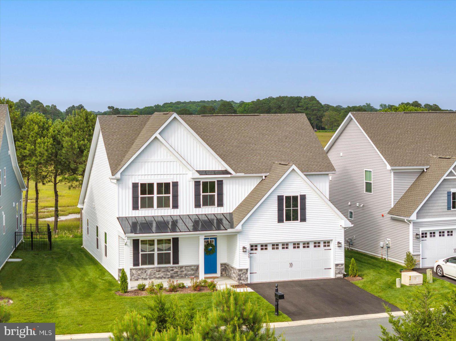 Don’t miss your chance to own one of the final Bayfront homesites available in the sought-after Landings at Bayside community! This newly built, upgraded Anderson model offers the perfect blend of coastal charm, thoughtful design, and breathtaking views. From the moment you arrive, the welcoming full front porch sets the tone for the stylish interior that awaits. Step into the foyer and versatile flex space, ideal for a home office, study, or sitting room. The main level flows beautifully into a bright and open great room that seamlessly connects to the gourmet kitchen, dining area, and covered rear porch, offering spectacular sunrise views towards Assateague Island. The kitchen is a chef’s dream, featuring upgraded cabinetry, stainless appliances, custom paneled refrigerator, quartz countertops, and a spacious pantry. The main-level luxury owner’s suite includes a walk-in closet, dual vanity, and a spa-like bath for your everyday retreat. A 2-car garage with interior access through the laundry room adds extra convenience. Upstairs, two additional bedrooms, a full bath, and a large loft space provide room for guests, hobbies, or additional family living. This amazing community offers resort style amenities that include a beautiful clubhouse with fitness center, indoor and outdoor pools, kayak launch, crabbing pier, and tennis courts. You will also appreciate the scenic nature trails, playground, and water views throughout the neighborhood. Less than 5 miles to Ocean City beaches and boardwalk, minutes to Assateague Island, famous for its wild horses and pristine coastline. Enjoy turn-key waterfront living in a newly built home with unmatched amenities and convenience. Whether you're starting your day with sunrise views or spending an afternoon lounging poolside, life at the Landings at Bayside delivers the ultimate coastal lifestyle. Schedule your private tour today—this rare Bayfront opportunity won’t last!