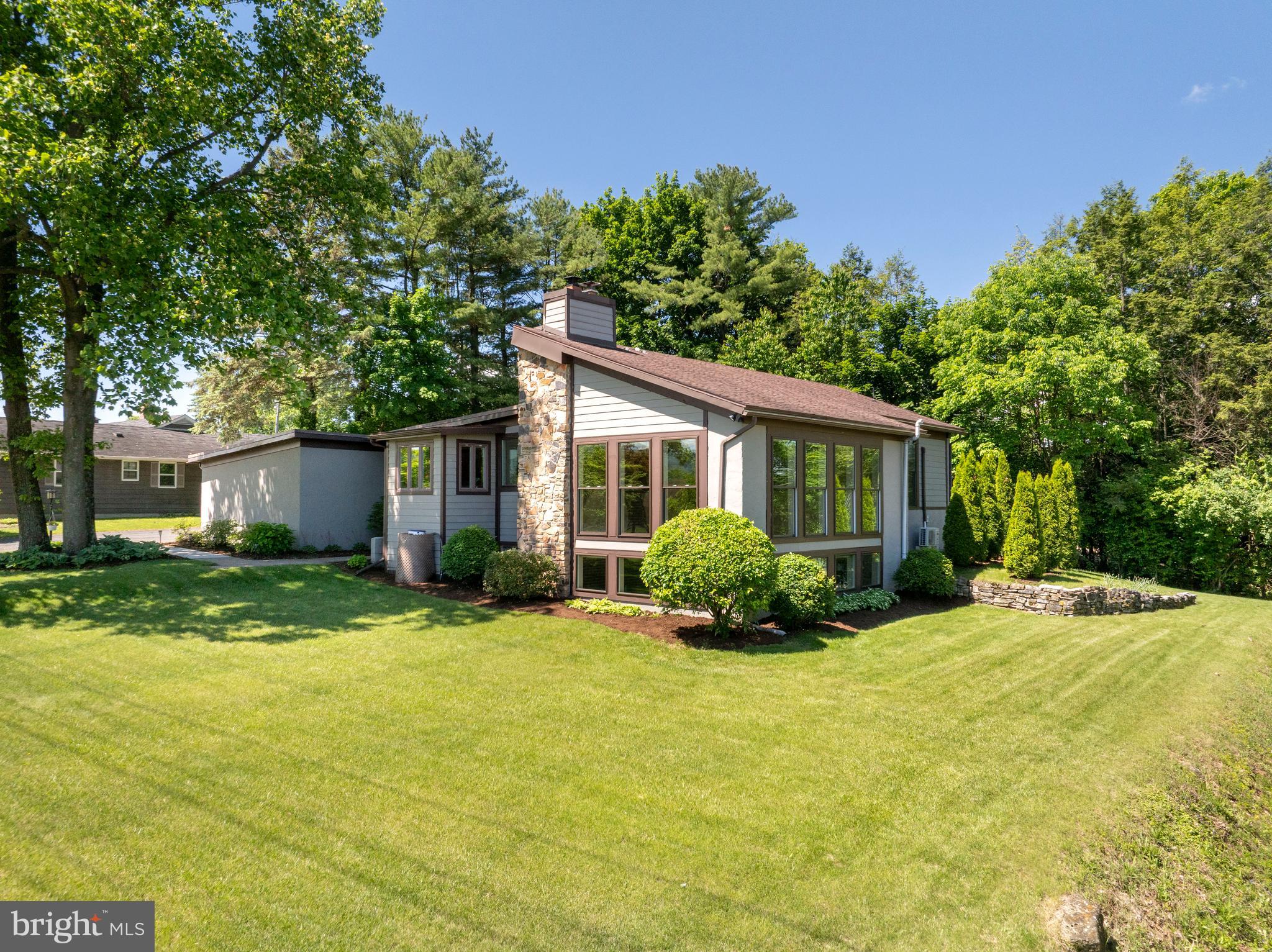 This one-of-a-kind contemporary home sits on a .43-acre lot with panoramic views in the highly desirable Nittany Hills neighborhood. Convenient location close to Penn State University and downtown State College. Designed with thoughtful details and solid craftsmanship, the home offers unique features, quality materials, and several recent updates.
The entry foyer welcomes you with natural light, new recessed lighting, slate tile and a quiet reading nook. From there, step into the kitchen, which includes stainless steel appliances, maple hardwood flooring, and a cozy eat-in area. The kitchen has an updated sink, garbage disposal, and lighting. Adjacent is a dining area with oak floors, a new ceiling fan, and new recessed lighting.
The sunken great room is a standout space with walls of windows, built-in shelving, and Russian masonry stone surrounding a Vermont Castings gas fireplace. It’s a comfortable space with plenty of room to gather & entertain.
The first-floor primary suite features Brazilian hardwood flooring and a new mini-split. The attached "Jack and Jill" bathroom includes heated ceramic tile, a jetted tub with tile surround, updated lighting, and new fixtures. The second bedroom can be found on this level. The guest suite on the main level offers a bedroom and full bath, ideal for guests or extended stays.
Recent improvements include new windows in the breakfast nook, a new bay window in the dining room, and a Craftsman shed. The concrete apron in front of the oversized two-car garage was recently replaced along with sections of the front walkway. The exterior has fresh new landscaping with beautifully manicured lawn. This is a well-maintained, distinctive home in a prime location—ready for its next owner.