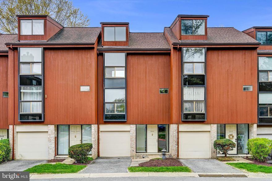 Tucked away in a quiet, treed section of Columbia’s Town Center Community of Glen Meadows and just minutes from Columbia Mall and major commuter routes, this four-story townhouse-condo offers nearly 2,000 square feet of comfortable living.  Start on the entry level, where you’ll find an attached garage with plenty of storage and a great workshop area for hobbies or gear. There’s also a cozy family room with a wood-burning fireplace—perfect for chilly evenings—and sliding glass doors leading to an outdoor space backing trees. It’s a great spot to sip your morning coffee or just take a breather at the end of the day.  Head upstairs to the main living level and you’ll find a spacious living and gathering room with big windows and tons of natural light. The kitchen has been recently updated with granite countertops, new cabinets, and stainless-steel appliances. There’s even a breakfast nook for casual meals and a powder room for guests. Up another level is the bedroom floor, where the primary suite features vaulted ceilings, a private bathroom, and a convenient laundry closet. The second bedroom is just down the hall, along with a full bath. And at the very top, there’s a finished fourth floor with a third bedroom that makes a great guest room, home office, or creative space. You can walk to the community playground, and everything Columbia offers is right nearby—shopping, dining, lakes, parks, and easy access to major routes. This home is sure to check your boxes: updated where it counts, spacious throughout, and surrounded by trees for that calm, tucked-away feel. Take a look and imagine life on all four levels.