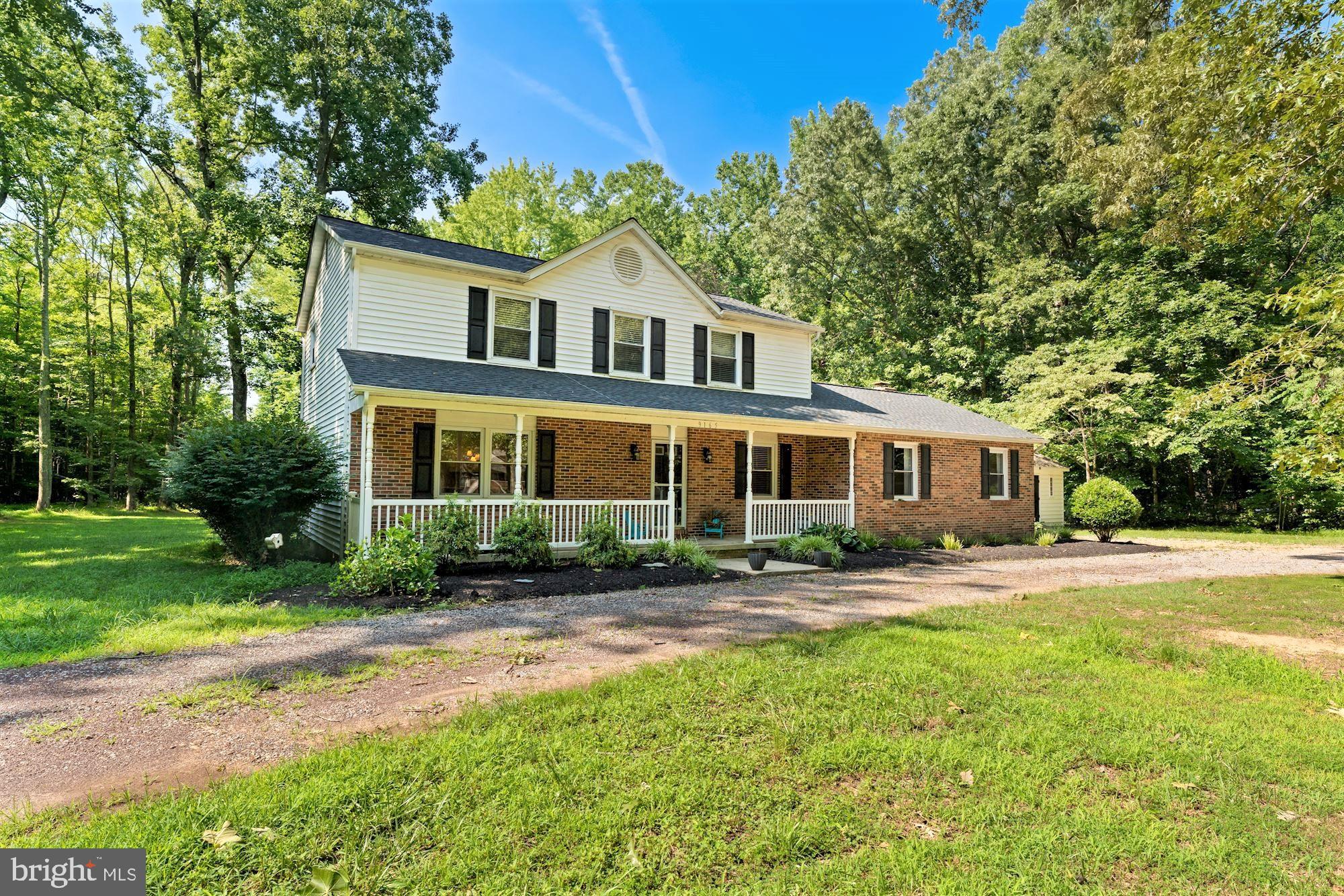 Charming colonial on a flat 2 acres and No HOA! Enjoy relaxing on your covered front porch in a quiet neighborhood. 4 bedrooms and 2 and a half baths. Expanded great room with wood burning fireplace, dual ceiling fans, and dual patio entrances. Enlarged kitchen with table space and breakfast bar, and loads of natural light. Home comes with a Smart Projector and screen for ease to plug in electronics. Circular driveway enables lots of parking and 2 sheds for ample storage. A must see!!!