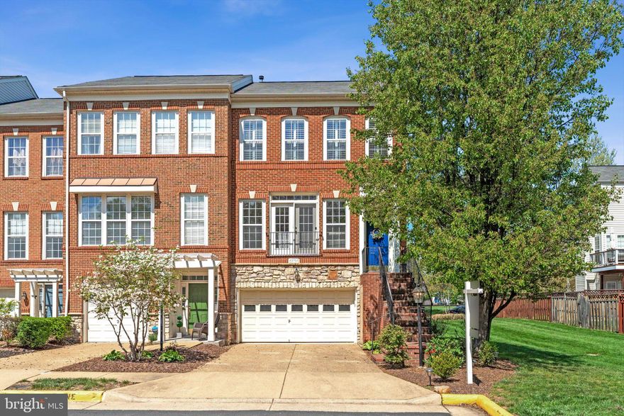 Discover refined living in this exceptional end-unit townhome in the highly sought-after Broadlands community—where convenience meets tranquility. Ideally located near the future Ashburn Metro Station, this residence offers seamless connectivity while enjoying serene, park-like surroundings.
Positioned on a quiet street, this premium end unit provides enhanced privacy, expanded outdoor space, and a fully fenced yard—ideal for entertaining, pets, or relaxing outdoors. Enjoy direct access to scenic walking trails and nearby playgrounds, all within a peaceful neighborhood setting. A thoughtfully designed three-level bump-out enhances the home with generous, light-filled living spaces.
Inside, hardwood floors span the main level, complemented by soaring ceilings, custom shutters, and refined architectural trim. The gourmet kitchen serves as the heart of the home, featuring a large center island, separate pantry, granite countertops, and stainless-steel appliances—including a wall oven, built-in microwave, cooktop, and side-by-side refrigerator with ice and water dispenser.
Upstairs, the luxurious primary suite offers hardwood flooring, two walk-in closets, and a private sitting area—perfect for a home office or quiet retreat. The spa-inspired bath is beautifully updated with a new frameless glass shower door, dual vanities, a jetted soaking tub, and a separate shower. Two additional bedrooms, a well-appointed hall bath, and convenient upper-level laundry complete this level.
The fully finished lower level provides exceptional versatility, featuring a spacious recreation room with a cozy gas fireplace and a full bath—ideal for guests, a media room, or fitness space.
Additional highlights include a two-car garage equipped with a new electric vehicle charger, ample storage, and plentiful guest parking. Major system updates, including HVAC and appliances, offer added peace of mind and long-term value.
Residents enjoy an unmatched lifestyle with HOA amenities that include three community pools, tennis and basketball courts, parks, playgrounds, miles of trails, and vibrant neighborhood events throughout the year.
This is luxury townhome living at its finest—offering space, sophistication, and an unbeatable location.