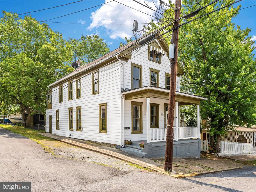 Charming colonial in the quaint town of Brunswick MD, close to shopping dining, Historic Harpers Ferry, and just off 340 for commuting and minutes to the MARC train station! Featuring fresh paint and new LVP flooring throughout the entire home. On the main level, a welcoming foyer leads to a nicely sized living room, separate dining room and updated kitchen with table space/breakfast area as well as stainless steel appliances and granite counters.  Convenient main level laundry with an abundance of storage space. Upstairs boasts a large primary bedroom with enclosed all season porch as well as two additional generously sized bedrooms and a full bath. Exterior features include fresh paint, cozy front sitting porch and fenced rear yard with shed.