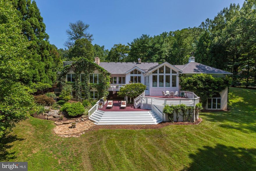 BIG PRICE REDUCTION!  Truly a must see in Potomac Falls to appreciate the value. Take the 3D tour  at  http://my.matterport.com/show/?m=wAsQD5KuiUhThis surprising gem of a home is elegant and sophisticated and sited on a coveted two-acre lot overlooking a pond. The custom-crafted interior will WOW you! The spacious entry foyer leads into a large, bright, open living room with built-in seating and a two- sided gas fireplace. The central dining room, with gas fireplace, opens to the deck and has a beautiful view overlooking the pond. The heart of the home is the beautiful, eat-in, gourmet kitchen with two ovens, two dishwashers, two sinks, a four-burner gas cook-top, beverage/wine cooler, separate ice maker, custom drawers, expansive counter space, and vaulted ceilings with skylights. The kitchen also includes a casual seating nook with built-ins and double-sided gas fireplace. Step down from the kitchen into the sunroom with a white, painted brick wall with gas fireplace and two walls of windows overlooking a tiered deck and the pond. Also off the kitchen are powder room and a large laundry / mud room which opens to the side driveway. The first-floor master bedroom suite is situated to take in the tranquil views overlooking the back yard and pond where you can see majestic blue herons cruising in over the water. The suite is further enhanced with his and her full baths and a very generously sized custom-built walk-in closet. Also on this level are a private guest bedroom and full bath.The upper-level suite is comprised of a bedroom with large walk-in closet, full bath, and a TV hide-away room with door to attic storage.The expansive walk-out lower level is finished to the same high standard as the rest of the home. High ceilings, walls of windows, and sliding glass doors to the exterior bring in loads of natural light. The family room, game room with pool table, full kitchen with bar seating, wood- burning fireplace and telephone booth make this a fun space to hang out with the family or entertain in. The magnificent home office, which was custom built with cherry cabinetry on three walls, has window views overlooking the three-tiered waterfall and lily pond, as well as bringing in the sights beyond of the sweeping yard and pond. This is not your average home office. It has a large, central-island desk space where two people can easily work. Adding to the fun factor of this lower level is a home theatre room with built-in screen and projector and a home gym you will want to work out in. The amazing gym space has floor to ceiling Palladian windows overlooking the back yard and pond. It is large enough for any and all equipment and the high ceilings, exposed brick walls and pendant lights give it an industrial like feel. Don t miss the gaming room, sure to be the envy of every gamer. This could also be used as a storage room. Rounding out the lower level is a full bath. VIEW the 3D TOUR http://my.matterport.com/show/?m=wAsQD5KuiUh