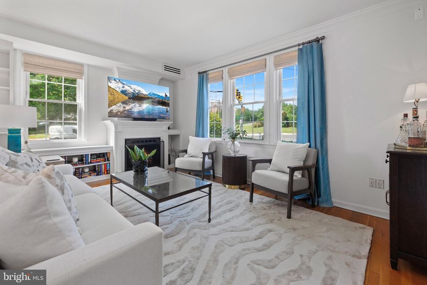 Offer deadline - Monday, 6/23 - 1PM - ABSOLUTELY CHARMING two bedroom condo with PERFECT Old Town location! This sun-drenched CORNER unit is an ideal private retreat, just steps to King Street metro and all that Alexandria has to offer!  Enjoy easy access to this ground floor unit via your private covered deck, complete with overhead fan - the perfect cozy spot for morning coffee or working from home in the fresh air! Inside, you will find a stylishly updated kitchen with quartz countertops, chic tile backsplash, upgraded hardware, stainless steel appliances, and a gas range. The large living area boasts a gas fireplace, built-in storage, and STUNNING views of Alexandria’s iconic Masonic Temple. Gorgeous hardwood flooring in the living room and bedrooms. This home has been thoughtfully updated throughout with built in storage in the closets, new light fixtures and fans, new toilet, and stylish new blinds. Laundry is a breeze with the in-unit stacked washer/dryer.  This location right on the cusp of Old Town and Rosemont is a dream for travelers and commuters alike - even closer than the metro station is Alexandria’s historic Union Station, where you can hop on Amtrak. Fancy a trip to New York? You can catch that train within a two minute walk! You can also grab the VRE there for a practically effortless commute to L’Enfant Plaza or Union Station in DC. If a stroll on Alexandria’s waterfront is more your speed, the FREE Old Town Trolley picks up at the metro station and will convey you to the heart of Old Town for historic ambience, along with world class shopping and dining! If flights are in your future, you can reach Reagan Airport in just 3 short stops on the metro or a quick 15 minute trip by car. This location is the very definition of walkable, but you are covered for car trips too with one assigned parking spot, guest parking, and convenient access to I-495 and I-395! Move right in and start living out your Old Town dreams!