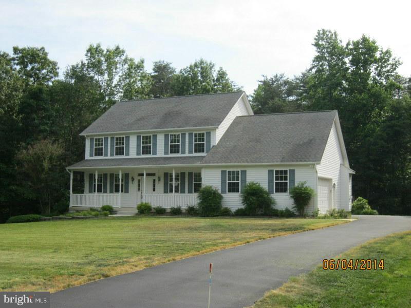 PRICED REDUCED!!Spacious 2 story colonial with welcoming front porch on over 2 acres. Bedroom on 1st floor , master bedroom and 2 more bedrooms plus den on upper level. Finished basement with 9 ft ceilings, new w/w carpeting, wet bar, full bath workshop and storage room. Kitchen features new granite countertops , new stainless steel appliances and ceramic tile floors. 2 car garage.