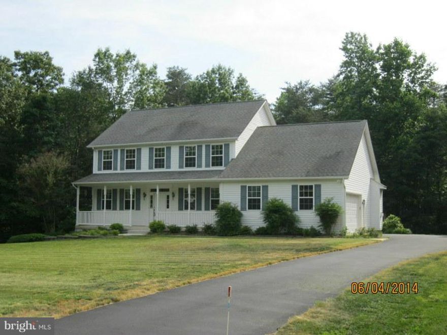 PRICED REDUCED!!Spacious 2 story colonial with welcoming front porch on over 2 acres. Bedroom on 1st floor ,  master bedroom  and 2 more bedrooms plus den on upper level. Finished basement with 9 ft ceilings, new w/w carpeting, wet bar, full bath workshop and storage room. Kitchen features new granite countertops , new stainless steel appliances and ceramic tile floors.  2 car garage.