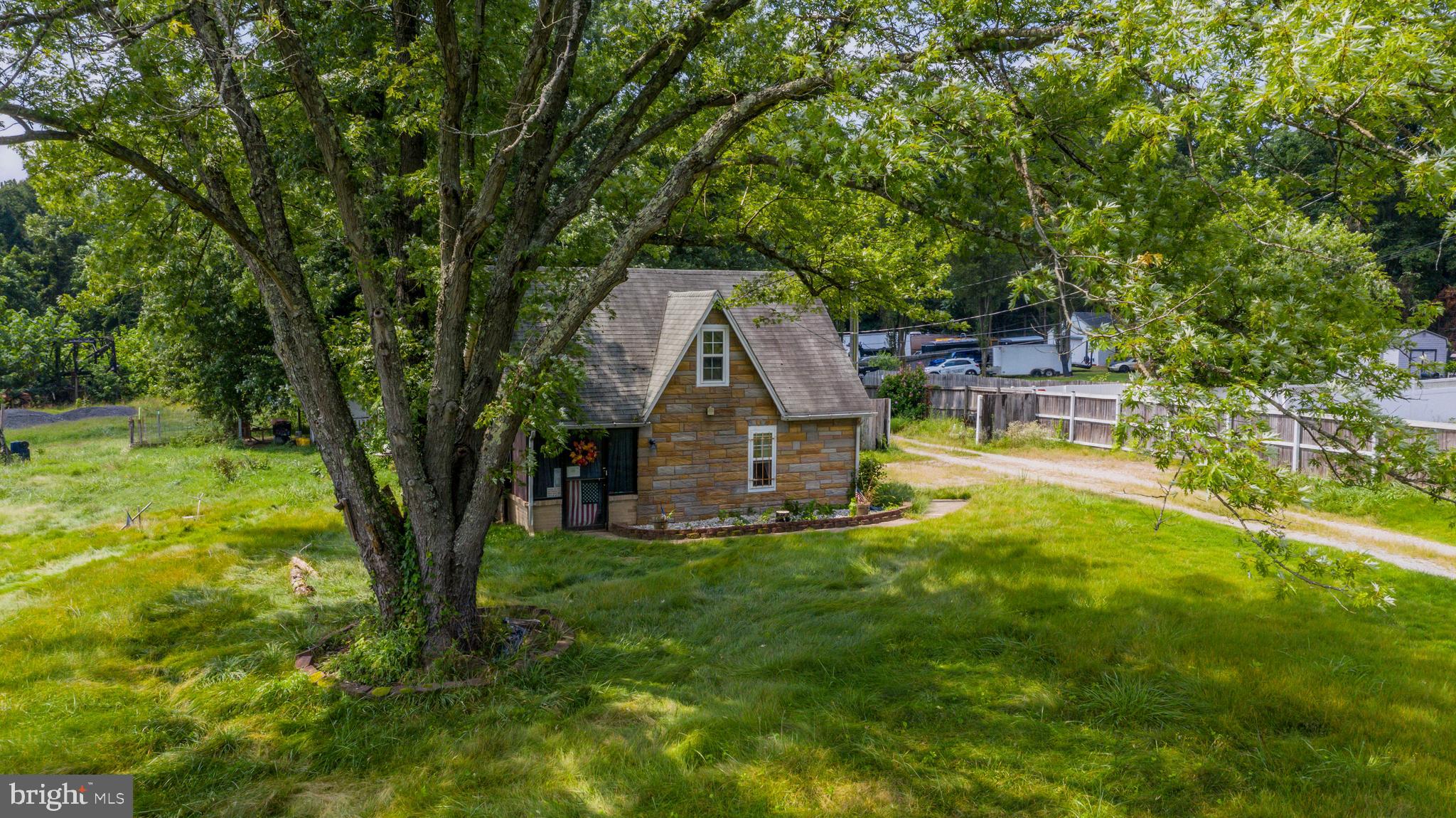 Discover the charm of this cozy Cape Cod-style home set on a scenic 11.38-acre farmette with endless possibilities. Whether you're dreaming of a home-based business, agricultural use, subdividing, or even commercial opportunities, this property offers incredible flexibility.
While the home itself is functional, the true value lies in the land's potential. Once home to American Legion Lodge #1778, the property features a peaceful pond, expansive cleared pastures, and a prime location just off major commuter Route 301. Best of all, there are no restrictive HOA covenants, giving you the freedom to bring your vision to life!