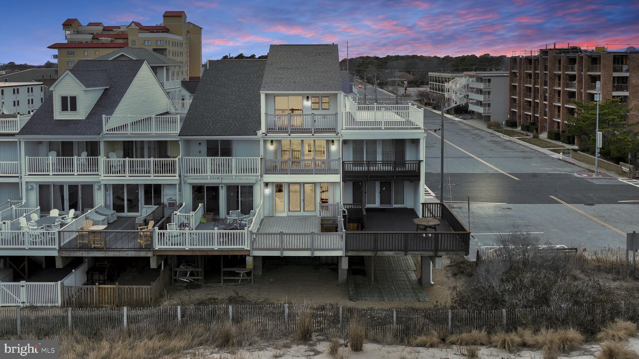 NO HOA! Experience the unparalleled allure of this magnificent oceanfront multi-level townhouse, mere steps away from the pristine beach, nestled in the highly coveted North Ocean City. Welcome to 14032 Wight Street, a residence that boasts a distinctive four-level floor plan designed for grand-scale entertaining and versatile hospitality, featuring five bedrooms, three bathrooms, and breathtaking panoramic views. The heart of the home lies in the spacious eat-in kitchen, strategically positioned at the center of the main level. Revel in the abundance of cabinetry, wine storage, a convenient breakfast bar, and an expansive dining area. Adjacent to the kitchen is the inviting living room, providing seamless access to a grand elevated ocean-side deck—an ideal setting for lavish gatherings or leisurely moments, basking in the sun's warmth while serenaded by the rhythmic crash of waves. This level also houses the primary bedroom with its ensuite, offering a tranquil retreat. Ascend the staircase to discover two additional levels of sleeping quarters awaiting your guests. Each bedroom on the upper level boasts a balcony with awe-inspiring views—two capturing elevated oceanfront panoramas and the others showcasing elevated North Ocean City vistas. Every floor features a hall bathroom and additional closet storage. The entry level unveils a spacious covered outdoor living space, a gateway to a backyard beach paradise that seamlessly leads to nature's majestic dunes and the pristine beaches of Ocean City. Revel in the knowledge that the beach is just a short stroll away, and you are in proximity to excellent uptown restaurants, shopping, and the vibrant nightlife that Ocean City has to offer. Whether as a perfect vacation home for a family or a lucrative income investment for your portfolio, this residence beckons. Seize the opportunity to claim your piece of the Ocean City lifestyle!