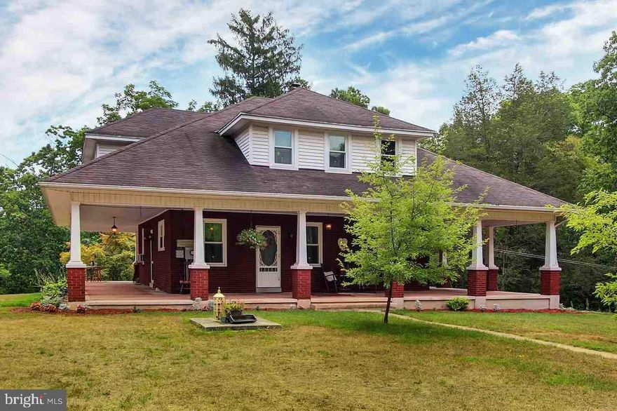 This stately lady just exudes character & charm. From the full wrap porch to the beautiful land backing to Bermudian Creek, you'll feel like you're on vacation year-round. Beautiful wood floors throughout, sep DR, LR w/brick fp, new kitchen, windows & electric. Explore your private cave and grab the kayaks from your boathouse for a float down the lazy river. This home offers the lifestyle you've been searching for and at a very affordable price!