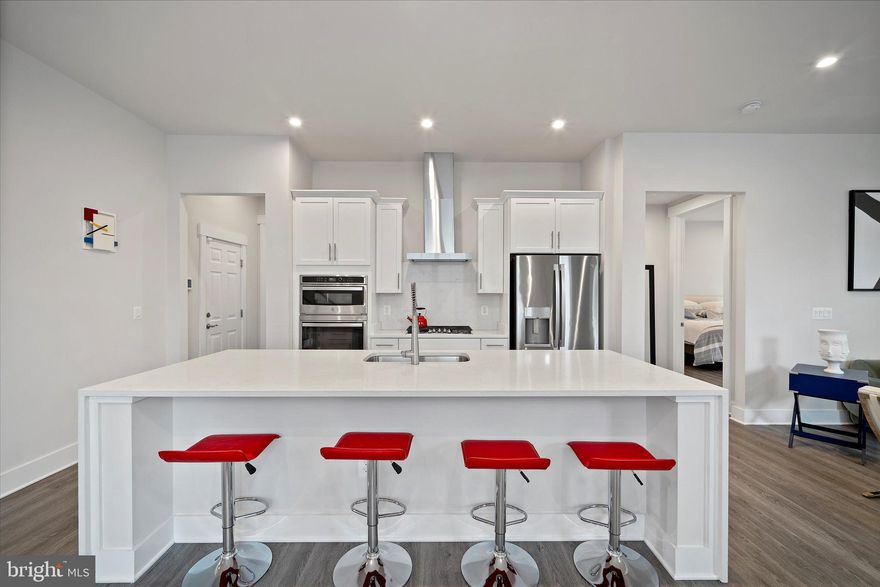 Welcome to this impeccably maintained, North/Northeast-facing home in a highly sought-after 55+ community. Built in 2021 and set on a premium lot backing to trees and a tranquil pond, this residence offers more than 3,500 square feet of beautifully designed living space across three finished levels.

The main level is anchored by a spacious primary suite featuring a spa-inspired en suite bathroom and a generous walk-in closet, providing comfort and convenience on one level. A thoughtfully placed half bath is perfect for guests. The gourmet kitchen showcases crisp white cabinetry, granite countertops, and stainless steel appliances, and flows seamlessly into the dining and living areas. A cozy gas fireplace adds warmth and ambiance, making the space ideal for both everyday living and entertaining.

Just beyond the living area, the screened-in porch invites you to unwind while taking in serene views of the surrounding trees and pond—perfect for morning coffee or relaxing evenings.

The upper level offers two additional bedrooms and a full bathroom, providing flexible space for visiting family, guests, or hobbies. Downstairs, the fully finished lower level expands your living options with a large recreation room, an additional bedroom and full bathroom, and abundant storage.

Additional highlights include a two-car garage, professionally maintained landscaping with lawn care included in the HOA, and the ease of living in a vibrant, low-maintenance 55+ community. With its premium lot, peaceful natural views, and thoughtful layout, this home delivers comfort, privacy, and effortless living.