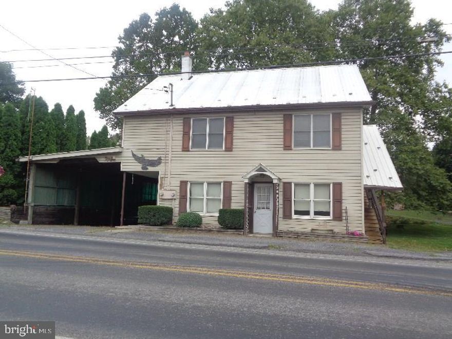 Duplex with attached carport and detached oversized garage/workshop.  First floor unit is a 1 bdrm and 2nd floor unit is a 3 bdrm.  Both units currently vacant.  All utilities separated.  Both have laundry hook-ups.  Rent both or live in one.  Both units have oil forced warm air furnaces & central air.  Community water/public & on-site septic.