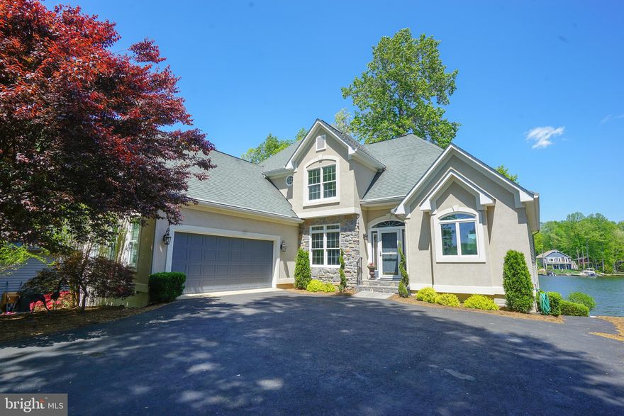 Rarely available custom luxury home on prime waterfront lot. One of the best coves on the lake. Views, views views and so many special features. Enjoy being right on the lake and take advantage of the extensive outdoor living space perfect for entertaining family and friends with boat rides, swimming and fishing. Take in quiet times with watching the bird-life and beauty of being on the water. Inside, the home has been thoughtfully renovated and bathrooms remodeled. Light, bright, neutral throughout. New carpet, paint, fixtures. Gourmet Kitchen with quartz counters, SS appliances and a large eat-in area that walks out to an all weather screened-in/ windowed sun porch. Grand great room with soaring ceiling and two level stone fireplace. Main level owners suite with newly remodeled spa like bath. Walk out finished basement with windows and views.  This home is a gem in the amenity packed Lake of the Woods Community. Experience golf, beaches, clubhouses with dining, community centers, new pools and fitness areas, security gate and fantastic clubs and events.  Feel a world away while still being close enough to Northern Virginia.