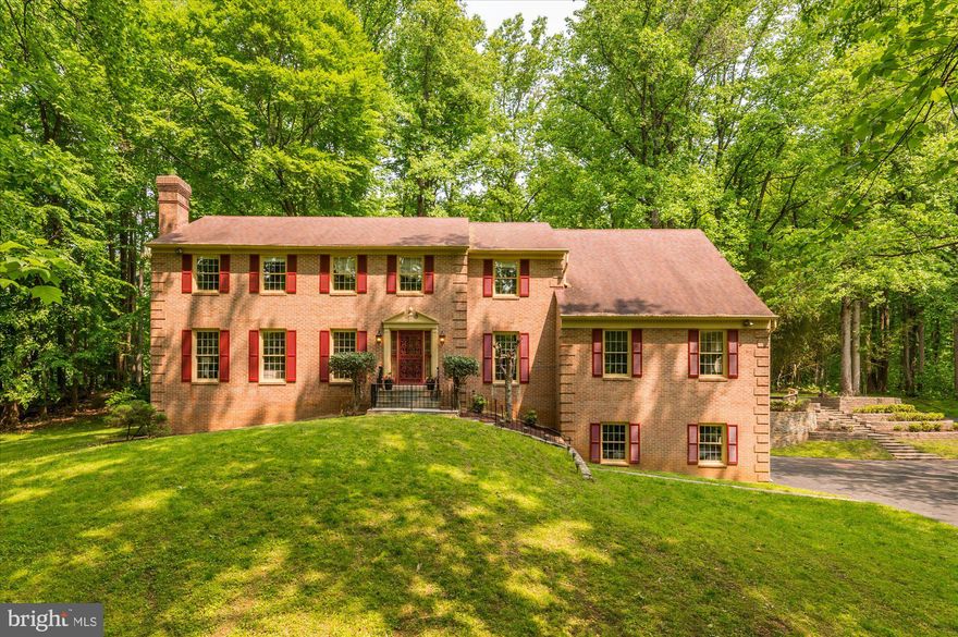 Wow!  What an opportunity to own a very private, 2 acre setting in the Mazza Woods neighborhood  (Whitman School Cluster) with its sprawling, tree lined lots close to the C&O Canal, the Potomac River & Billy Goat Trail.  This classic, 6,000+ SF, all brick colonial stands perched on a hillside offering both beautiful views from the ample windows and near total privacy. The welcoming Entry Foyer opens up to the private Study on one side and the sun drenched formal Living Room on the other.  The Living Room has high ceilings, hardwood floors and a brick fireplace along with floor-to-ceiling windows.  The Formal Dining Room with chair rail and decorative moldings is adjacent to the Living Room.  It leads next through the Butler's Pantry with excellent storage, past the Laundry Room and into the spacious, eat-in Kitchen.   The separate Laundry Room is with lots of built-in cabinetry is right off the Kitchen allowing you to multi-task easily!  The Kitchen also has excellent storage,  granite counter tops, stainless steel appliances & a wine/beverage cuvee.   The Kitchen has a Breakfast/ Eating Area with a Bay Window and Built-Ins looking into the Family Room.  The storage and counter space in the Kitchen is awesome for anyone who likes to cook or bake.   The adjoining Family Room is exceptionally well proportioned, has a wood burning stove with a dramatic floor-to-ceiling fieldstone surround along with French doors leading to the rear yard. Just off of the Family Room is a sizable bonus room that could be anything from your own Home Theater,  Billiard Room, Music Room or second Home Office/Library.  Upstairs, the Primary Bedroom is incredibly spacious and leaves nothing to be desired. With its Sitting Room, Dual Walk-In Closets and En Suite bath it has all the space and features you could want. Four additional bedrooms with two full bathrooms complete the Upper Level. Possibilities abound in the Lower Level.  Previously, this Owner had a County Permitted Home Office with half the Lower Level utilized as a full dental suite.  Accountants, attorneys, therapists, dentists or anyone who wants to run a business from home will find a terrific option here.  The third garage bay was used to create the Office Reception Area then there are Two Private Offices and a half bathroom.   The other half of the Lower Level includes a Recreation Room, Hobby Room, Full Bath and Storage Space.  It is possible to return the Reception Area to a third car garage.   Outside you will be charmed by birds singing among the trees.  The proximity to the River brings migrating birds and a wonderful selection of local birds to the yard.  An older deck off the Family Room was removed and now the space awaits your design dreams - a stone terrace and outdoor fireplace? an oversized deck or screen porch.  Bring your imagination!  Ideally located just off the Clara Barton Parkway, River Falls offers easy access to all major commuting routes:  I-495, the Beltway, north to the I-270, BioMed Corridor or south to Tyson's Corner, VA or the parkway into downtown Bethesda or DC.  Both area airports are within a half hour non-rush hour drive.  For the outdoor enthusiast, Great Falls National Park is minutes away for hiking, kayaking, climbing the stone face of Billy Goat Trail,  biking into Georgetown.  In another two months, the River Falls Swim/Tennis Club will be in action with a winning MCSL swim team and a Junior Tennis Team.  Other activities include men's and women's tennis teams, pickle ball, Camp River Falls and the ever popular July Fourth parade and picnic.  Please ask about Class C Memberships at the River Falls Community Center.   Carderock ES, Pyle MS and Whitman High School, ranked #1 high school in MD by US News & World Report.  Stop your search!  You've found it all here!