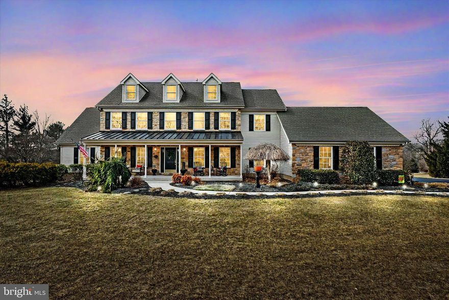 Welcome to The Estates at Brookside and 4020 Fountain Circle, a distinguished residence in this exquisite enclave of 33 homes nestled in bucolic Fountainville, PA, just minutes from Doylestown. Originally  the builder’s own home, this stunning property seamlessly blends understated elegance with modern comfort, offering a truly exceptional living experience.
As you approach, lush, meticulous landscaping sets the tone for the warmth and character that define this home. The expansive farmhouse-style front porch invites you to sit back on a rocker or sway on the porch swing while taking in the serene surroundings.
Step through the gracious foyer, where a living room (currently an office) sits to the left, and on the right, a spacious dining room with elegant case wainscoting and crown molding. Make your way through the foyer to the light-filled, two-story family room, where a fireplace with stone surround and shiplap accents creates a cozy retreat on chilly evenings. The family room flows seamlessly to the heart of the home, the country kitchen with breakfast area and center island. The kitchen features newer stainless-steel appliances, quartz countertops (2021), tile backsplash and abundant cabinet space. The first-floor laundry/mudroom with granite countertop (2021) provides access to the 3-car attached garage.
Down the center hallway to the other side of the home, you’ll find a recently refreshed powder room and the gracious 1stfloor primary suite. Tucked in its own wing, the primary suite is a secluded retreat with a huge ensuite bathroom with dual granite-topped vanity, two linen closets, a generous walk-in closet and direct access to the deck and hot tub. 
Upstairs, an open walkway overlooks the family room, enhancing the home’s open, airy feel. There are three large bedrooms and a full bath. One bedroom has a very large walk-in closet, which leads to a full staircase to the massive attic. A door from the center bedroom provides access to additional storage space over the garage. 
The kitchen may be the heart of this home, but if you’re looking for additional recreation or entertainment space, you’ll find it in the fabulous finished basement. Designed for both relaxation and recreation, the basement is a standout feature, offering a second full kitchen and a full bath. Game tables (pool, foosball and shuffleboard) and electronic slot machines are included with the sale. An unfinished area currently serves as a workout space, but could also provide additional storage or a workshop area. With direct egress to the yard, the basement could potentially become an in-law or au-pair living area.
Outdoor living space? You’ll find it here! Set on over 3 acres, this property provides plenty of room to roam or relax. The composite deck spans nearly the length of the home and affords sweeping vistas; a motorized awning provides shade and two exterior closets supply extra storage. Imagine relaxing evenings in the hot tub under the stars. Or gather around the built-in fire pit – perfect for crisp nights with friends and family.
A staircase at the rear of the property leads to a wooden bridge over a babbling brook and a truly unique feature: a detached 4-bay garage with its own driveway–a dream for car enthusiasts, collectors, or hobbyists. Measuring approx. 30’ X 60’, this garage offers heavy power and workshop space. For fun, there’s even a pickleball court with a portable net!
A 2-zone heating and cooling system with 3 air handlers ensures comfort throughout the house. There are a 75-gallon propane water heater, a water softener, 2 sump pumps and an on-demand generator.
This home offers exceptional craftsmanship and pride of ownership with thoughtful updates including brand-new (2025) flooring throughout the first floor and updated lighting and faucets. A neutral color palette offers the perfect backdrop for your personal touches. This home is a must-see for the discerning buyer - schedule your private tour today!