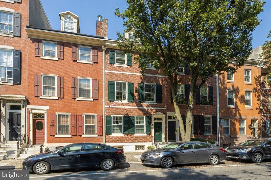 This classic 1808 Society Hill Federal style townhouse in excellent condition with gracious scale throughout is on a wide and deep lot in a desirable location minutes to all city points of interest including great parks, restaurants, and shopping.  Included in the sale is a transferable leased garage parking space 2 blocks away at a $1,500 year cost to the new owner with many years left on the original 99 year lease.  The house interior incorporates beautiful original millwork and wide plank flooring details blended with a terrific floor plan highlighted by many windows, skylights, great closets. The owner has loved living here and it shows!  2 zone HVAC, upgraded electrical system, newer roofs, newer deck, great kitchen, newer baths. There is an alluring patio with an art installation trough style fountain and beautiful plantings for a true urban oasis, and a 2 level roof deck with straight stair for an escape to neighborhood views and skyscape.  Vestibule to entry hall. Large living room with a most handsome black marble fireplace.  Central hall with large coat closet,  lovely powder room, beautiful staircase to second and third floors. The dining room is a big, bright surprise with bay area and skylights, great storage closets.  The bright, large eat-in kitchen with a well thought out plan has quality cabinets with terrific storage, granite counters, gas range, double wall oven (one is a microwave), skylight – this great  space is flexible enough to have an eating and sitting area near the glass doors opening on to the quite special brick/stone patio. The fantastic patio has side beds with beautiful plantings and a drip watering system,  tranquil water feature. The second floor has a center hall.  Large front bedroom with fireplace now used as a library.  Big rear primary bedroom with 2 large closets, linen closet; primary bath with walk-in shower, tub, double vanity.  Third floor center hall with skylight.  Big front bedroom with gas fireplace, 2 large closets.  Hall bath with walk-in shower, bidet, and double vanity, skylight.  4th Bedroom now used as an office with built-in desks/cabinets, closet with sink/cabinet/small refrigerator, 2nd closet, glass door to newer 2 level roof deck with straight stair connecting both levels.  Third floor hall has door with stair to fourth floor attic room with storage and mechanicals.  The pleasant basement with laundry, sink, mechanical systems, also offers a cedar closet and a workshop/project area.  731 is designated on the Philadelphia Register of Historic Places. This prime location is close to all of the city’s great amenities and cultural attractions including beautiful Washington Square and Independence National Historic Park.