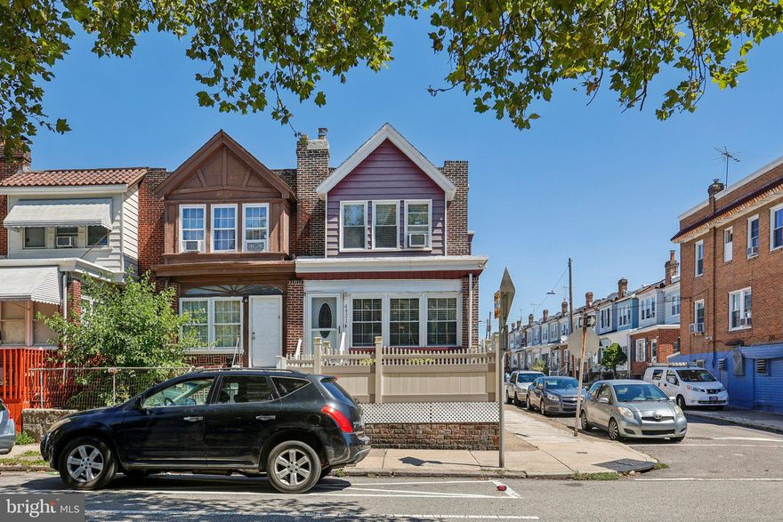 Pristine and beautifully updated, this 3-bedroom end row home in the desirable Tacony neighborhood of Philadelphia offers charm, functionality, and rare off-street parking. Boasting great curb appeal with a large front deck, the home welcomes you through an enclosed porch into a stunning living room featuring gleaming hardwood floors, crown molding, and a decorative brick fireplace. The formal dining room flows seamlessly into the modern kitchen with new appliances, abundant cabinet space, and access to the rear driveway and a detached 2-car garage—a true city luxury. Upstairs, you’ll find two spacious bedrooms and two full bathrooms, including a large Primary Suite with its own ensuite bath. The finished basement provides incredible versatility with a third bedroom, third full bath, kitchenette, and laundry area—perfect for guests or multi-generational living. *Mortgage savings may be available for buyers of this listing.*