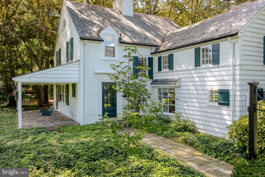 Tucked off Millersville Pike in Lancaster Township, this 1939 English cottage-style estate offers a desirable combination of charm, privacy, and flexible living spaces. The property includes the main home and a private apartment, situated on a one-acre lot. A circular driveway welcomes you into this private retreat surrounded by mature trees and thoughtful landscaping.

The main home features 2,936 square feet, and the apartment adds an additional 740 square feet. Together they include five bedrooms, three full and two half baths, and four fireplaces. The family room offers built-ins, a fireplace, and access to the patio—an ideal spot to relax or entertain.

Recent improvements reflect careful maintenance and attention to detail, including a total replacement of the porch and its slate roof, updates to the slate and copper flashing on the house and garage roofs, and fresh paint inside and out. The insulation in the second-floor storage room was also replaced, and both front doors received new lock mechanisms. The newer gas-fired furnace and on-demand water heater replaced the original oil system, offering efficient and reliable comfort.

Above the oversized two-car garage, you’ll find a one-bedroom apartment complete with a living room, full kitchen, bath, laundry, and private entrance. This versatile space is close by yet completely separate—perfect for extended family, guests, or rental income. The fenced yard, flagstone courtyard, large shed, and beautiful surroundings add to the property’s appeal.

With its inviting character, flexible spaces, and unmatched setting, this home is best experienced in person.