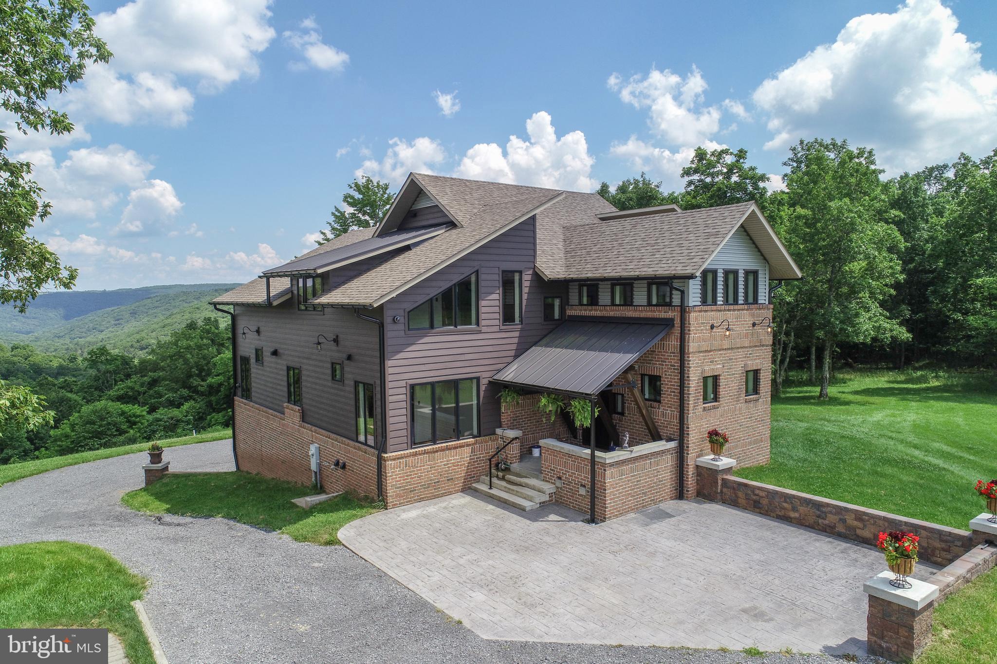 One of Garrett County's most unique and breathtaking estates—this completely custom masterpiece is set on over 63 acres of pristine land, offering unmatched privacy, panoramic valley views, and endless possibilities. Designed with meticulous attention to detail, this extraordinary home features radiant in-floor heating, a gourmet kitchen outfitted with restaurant-grade appliances and a full butler’s pantry, and a luxurious main-level primary suite. The expansive family room opens to not one, but two attached garages for ultimate convenience. Outside, follow scenic trails past several outbuildings to a year-round stream, winding through a stunning mix of open fields and wooded acreage. A rare blend of elegance, seclusion, and natural beauty—this is truly a once-in-a-lifetime property.