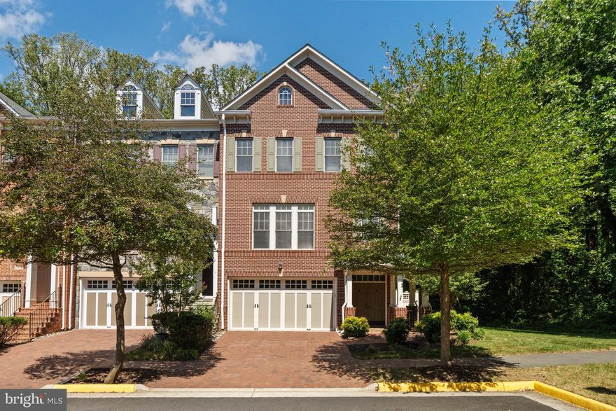 Welcome to 6726 Darrells Grant Place - expanded Barclay model in the sought-after Stockwell Manor community. Beautiful brick, three-level, END-UNIT townhome with bump-outs on every floor offers over 3,100 square feet of living space and lives like a single-family home. The main level features a bright and open floor plan with hardwood floors, spacious living and dining area, deck with a retractable screen door, and chef’s kitchen with updated appliances, including a new wall oven and microwave combo with air fryer. Upstairs, you’ll find three spacious bedrooms, including the primary suite with a tray ceiling, attached office/den, walk-in closet with custom organizers, and a spa-like ensuite bath. Bedroom 2 & 3 with a hall full bath and separate laundry room with cabinetry adds convenience. The walk-out lower level is an entertainer’s dream with a custom wet bar, luxury cabinetry, stone countertops, gas fireplace, built-ins, sound system, a half bath, storage room, and access to the two-car garage with an electric car charger, custom flooring, and cabinetry. The fenced-in back & side yards backing to 30-acre Haycock-Longfellow Park and showcases $25k+ in hardscaping, creating a private retreat. Additional features include custom built-ins, Closets Stretchers organizers throughout, tankless water heater, water softener system, ADT security with cameras and sensors, and recent updates such as a new cooktop and exhaust (Sept 2025), walk oven & microwave combo with airfryer (March 2025), dishwasher (2023), oversized gutters with guards (2021), refrigerator (2019), and island beverage fridge (2018). The HOA covers all lawn maintenance, including private fenced-in yard. Ideally located in the McLean High School pyramid and just steps to Haycock Elementary, this home is minutes to West Falls Church Metro, Tysons, McLean, shopping, dining, and commuter routes including I-66, I-495, and the GW Parkway. ***OFFER DEADLINE: Sunday, September 14th at 8pm. ***