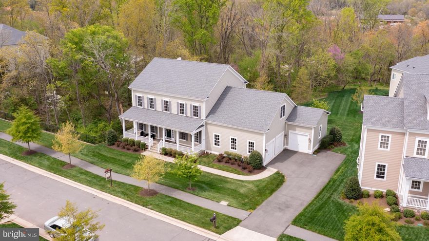 This beautiful K. Hovnanian built extended Groveton model will impress you at every turn! Largest Groveton in the neighborhood is situated on a .33 acre cul-de-sac lot with gorgeous view of trees.  This 6 bedroom, 5.5 bath, 3-car extended garage will delight you with it's many features. Enjoy the open floor plan, distinctive layout, crown molding, tray ceilings, custom blinds, shiplap, feature wall in bar area and amazing outdoor living spaces.  MAIN LEVEL:  Imagine coming home to this welcoming front porch and stunning extra wide foyer leading past the living and dining room to the back of the home!  Here you will enjoy creating meals in your gourmet kitchen which opens to the inviting family room with a stone front fireplace.  The extended sunroom with shiplap walls are a great backdrop to this space and leads to a huge trex deck overlooking trees and making it the perfect space to gather and enjoy a relaxing evening with your family or friends. You can enjoy a more casual meal in the breakfast room off the kitchen.  Additionally you will find a private office just off the family room and a separate built in desk area for two off the eating space in the kitchen! There is plenty of space for everyone!  The generous pantry and mud room finish off this level!    UPPER LEVEL:  Split staircase leads to the open and spacious upstairs hallway and generous loft area. The stunning primary suite welcomes you with a double door entry and bump out and sitting area. The gorgeous tray ceiling and tons of windows overlooking trees make this room a nice retreat. Opulent primary bath with separate vanities and large shower with double shower heads. A enjoy the generous sized walk in closet!  Additionally, 2 linen closets in the primary bath area provide many options for storing your items.  ALL 4 bedrooms on the upper level are spacious and provide plenty of large or walk in closets.  ALL bedrooms on this level have their own private en-suite bath. The loft area provides for endless opportunities! LOWER LEVEL: This home inspires entertaining with ease!  The theatre is the perfect spot to enjoy movies without ever leaving your home.  Gorgeous wet bar with wine fridge and seating welcomes your family and friends for small and large gatherings.  The recreation room is the perfect space for conversation or just enjoy watching a game!  Additionally, 2 bedrooms and full bath are located on this level.  Walk out to your patio and serene back yard. OUTDOOR SPACE:  Enjoy the great outdoors and absolutely gorgeous sunsets!  A 7-zone Rain Bird irrigation system, beautiful view of trees and tranquil setting round out this home and make it easy to enjoy the sights and sounds of nature!  Call today to learn more about Willowsford and this stunning home! Sought after, award winning, community with tons of amenities and located near shopping, restaurants and future metro.  You will love it here!