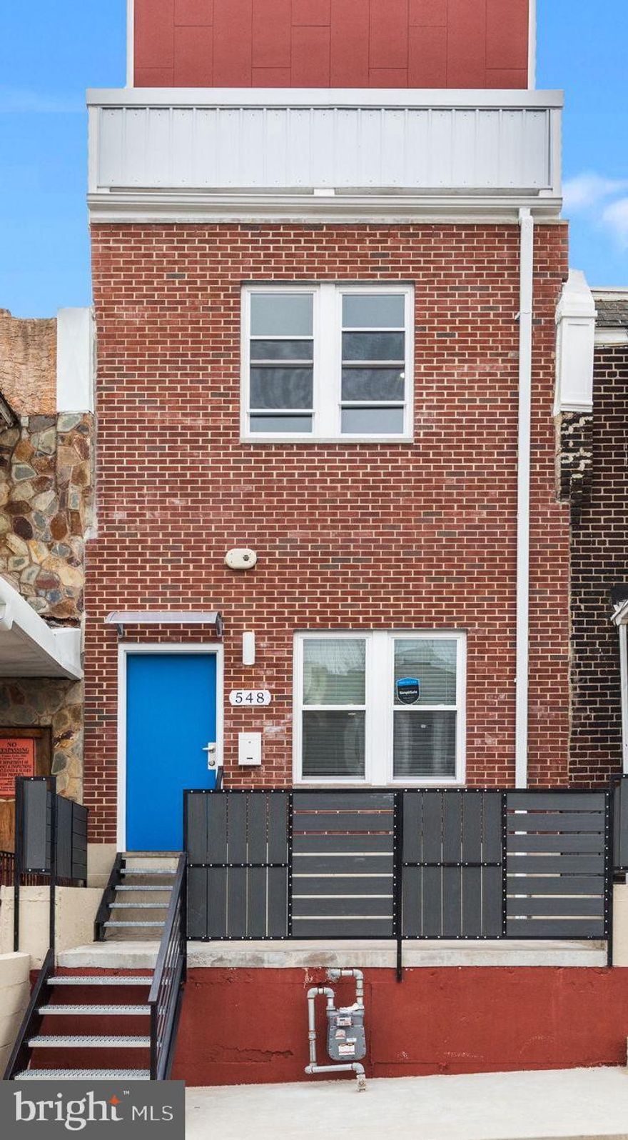 Welcome to 548 E Mayland Street, an exceptional move-in ready townhome featuring 4 bedrooms and 3.5 bathrooms, situated in the highly sought-after East Germantown neighborhood. Upon entering, you will be greeted by an abundance of natural light and elegant large plank flooring throughout the home. The spacious living room seamlessly flows into an open-concept kitchen, which is a culinary enthusiast's dream. The kitchen boasts 42-inch slow-close two-tone cabinetry, stunning marble countertops, an oversized island, and brand-new stainless steel appliances, including a gas stove, built-in microwave, dishwasher, refrigerator, and sink with garbage disposal. Recessed lighting enhances the ambiance throughout the entire home. The second level features two generously sized bedrooms, a custom full bathroom, and a well-appointed laundry room equipped with a washer and dryer. The entire third level is dedicated to a luxurious primary suite, which includes a sitting area with a wet bar, a private balcony, and an in-suite bathroom complete with a tiled stall shower, double sink vanity with a makeup sitting area, and two walk-in closets. Ascend from the third floor to the rooftop deck, offering breathtaking 360-degree views of the city. The finished lower level provides full bathroom additional space that can be utilized as an extra bedroom plus more space for game room, living room, etc. Conveniently located off the kitchen is a fenced-in yard, perfect for grilling and relaxation. The home features a new HVAC system and offers easy access to Lincoln Drive and Germantown Avenue, with just minutes to Center City Philadelphia and Chestnut Hill.
