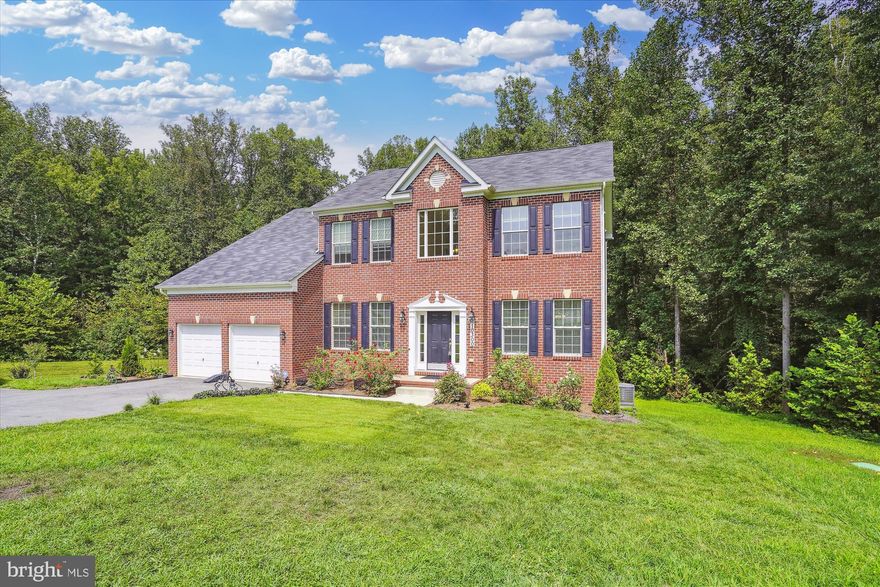 Nestled at the bottom of a quiet cul-de-sac in the highly sought-after Duvall community, this gorgeous brick-front Colonial built by Caruso Homes in 2019 is prominently sited on a fantastic piece of property boasting 5 bedrooms, 3 full bathrooms, a half bath, fully-finished walk-out basement and a two-car garage.

A two-story entrance welcomes all to the main level.  Substantial living and dining spaces are enhanced by large, bright windows and tons of natural light with a flowing layout that is ideal for hosting gatherings or more intimate living. 
The kitchen is fully equipped for preparing gourmet meals with gleaming granite countertops, built-in stainless-steel appliances, an island with a cooktop, abundant cabinetry, and ample pantry storage for all your culinary endeavors.  Enjoy breakfast in the morning room with a spectacular view of the wooded backyard and retreat to the sunken family room for ultimate relaxation and quality time after a long day.  An office is perfect for hybrid or work-from-home professionals and a powder room completes the main level.

Upstairs finds four generous bedrooms served by two well-appointed bathrooms including an enormous primary suite.  The luxurious spa bathroom boasts dual vanities, a soaking tub, and a huge walk-in double shower stall with floor-to-ceiling tile and frosted glass windows.  There is also an upper-level laundry room for your convenience.   

The sprawling lower-level provides tons of space for games and recreation, a bonus room-perfect for setting up a home theater/media room, and a fifth bedroom and full bathroom provide guest accommodations.
Step outside and enjoy closeness to nature in privacy, surrounded by tranquil woods.  Move-in worry-free and love your lifestyle at 10300 Samuel Gordan Pl!