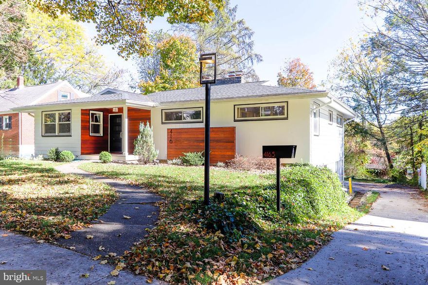 Iconic, historic charm of mature tree lined Irvin Ave within the Highlands neighborhood of the State College Borough, 416 E Irvin encapsulates mid-century charm and modern amenities.  Built in 1956, this single-story ranch features - hardwood floors, a first-floor primary bedroom, a spacious eat-in kitchen and a permitted one-bedroom apartment with income potential.  Celebrating the hallmark of mid-century modern design, floor to ceiling windows in the main living room and dining room invite the outside in, a sandstone trimmed fireplace, built in shelves and newer bespoke light fixtures give a nod to this time period. 

A sprawling kitchen with abundant storage is framed in shaker style solid oak cabinetry with tile backsplash and floors.  Professionally renovated bathrooms (2019) are a spa-like retreat featuring elongated picket tile walls and retro inspired tile floors still maintaining the charm of the original era.  Custom vanity and globe pendant light in the main bathroom create a warm and designed forward space.  Additional living area in the lower-level features large windows, built-ins, closets, another sandstone fireplace and knotty pine paneling embracing the timeless character of this flexible living space.  A fully equipped laundry room with washer and dryer with walkout access to the outside and an additional fully renovated bathroom with tile shower complete the lower level of the main house.  The separately metered lower-level apartment with separate entrance consists of a living room, one-bedroom, full kitchen, bathroom and washer and dryer, currently rented for $850/month, providing a fantastic opportunity for supplemental income or an in-law suite.

Step outside to a tree lined backyard oasis complete with expansive wood deck, ideal for grilling, dining and gathering with friends. The generous lot features plenty of green space, a playlet and a large driveway with ample parking - a rare find this close to campus.  Just blocks from Penn State University, this stylish home (with new roof, gutters and exterior design features, 2019) offers the perfect blend of convenience to campus and residential tranquility.  Whether you’re heading to a game at Beaver Stadium, enjoying the Central PA Festival of the Arts or grabbing a coffee downtown, everything is just minutes from your front door.